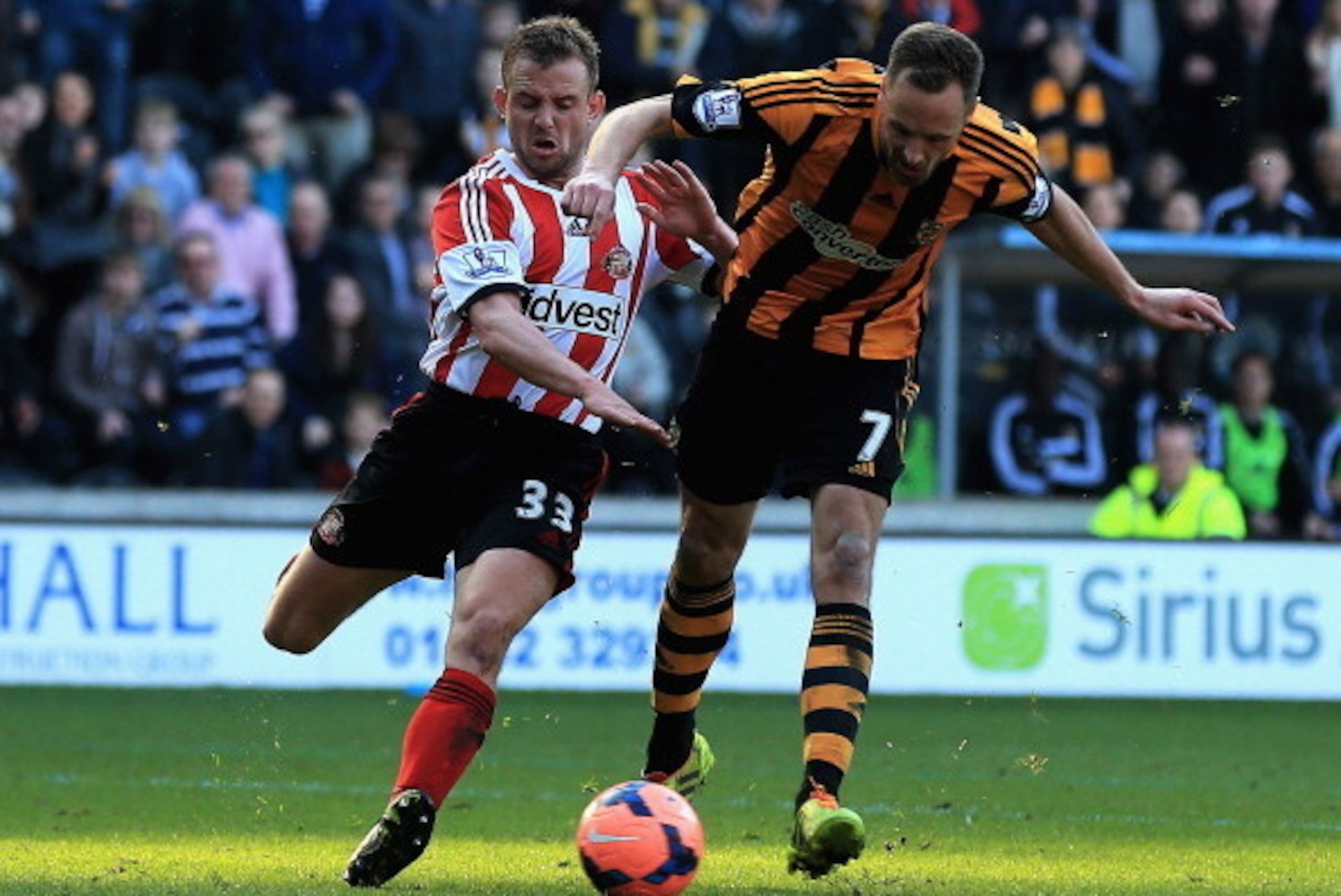 HULL, ENGLAND - MARCH 09:  David Meyler of Hull City beats the tackle from Lee Cattermole of Sunderland to score his teams second goal during the FA Cup Quarter Final match between Hull City and Sunderland at KC Stadium on March 9, 2014 in Hull, England. 