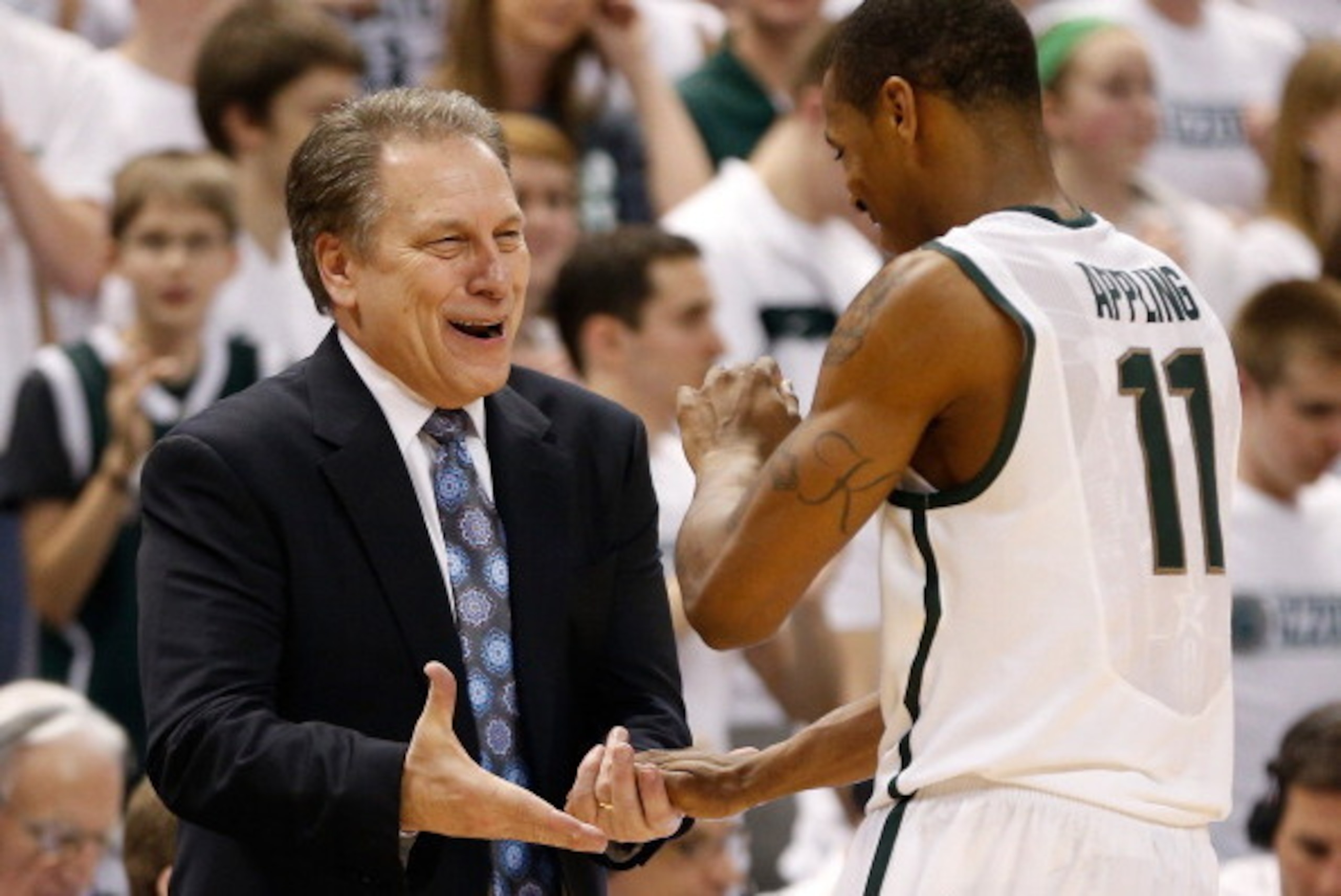EAST LANSING, MI - MARCH 07:  Head coach Tom Izzo of the Michigan State Spartans congratulates Keith Appling #11 as he leaves the floor in the second half while playing the Wisconsin Badgers at the Jack T. Breslin Student Events Center on March 7, 2013 in