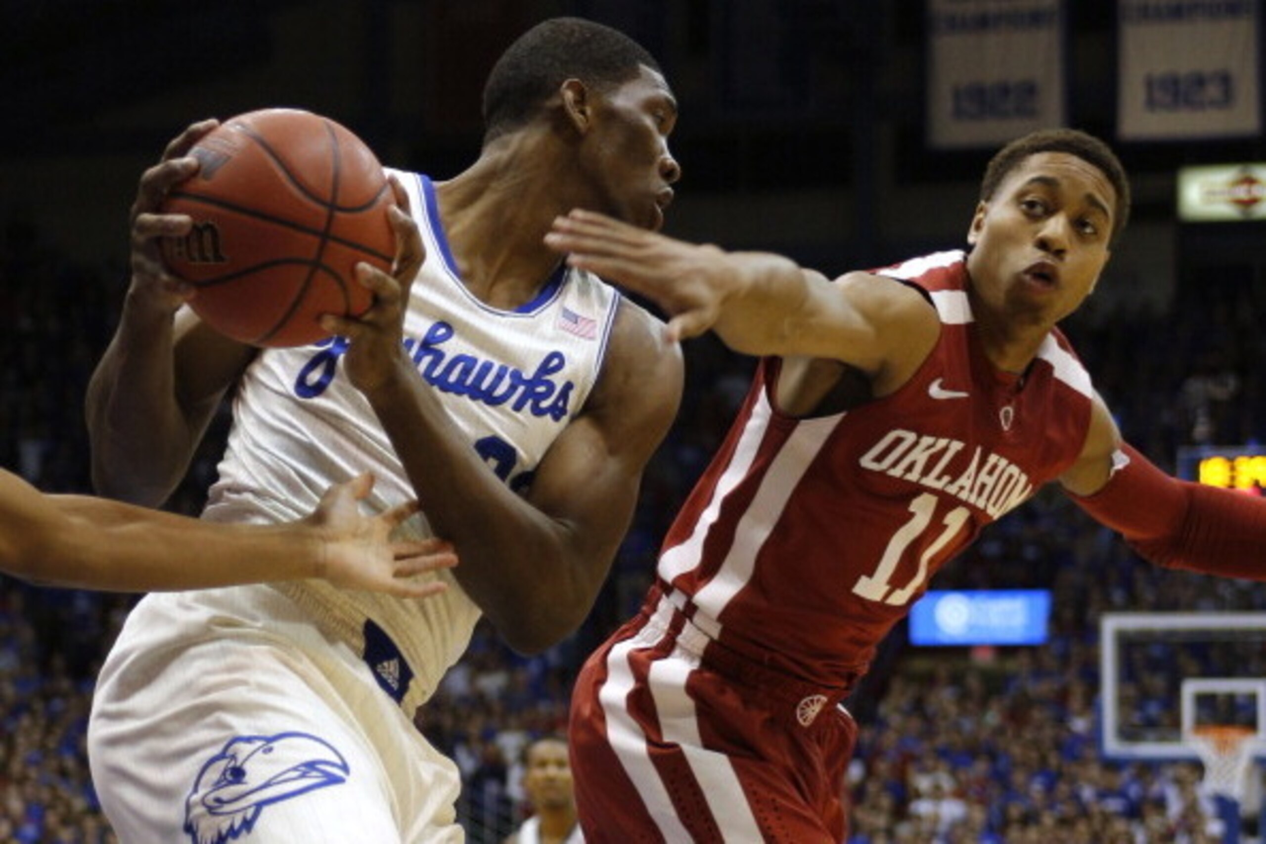 LAWRENCE, KS - FEBRUARY 24: Joel Embiid #21 of the Kansas Jayhawks grabs a rebound against Isaiah Cousins #11 of the Oklahoma Sooners in the first half at Allen Fieldhouse on February 24, 2014 in Lawrence, Kansas. (Photo by Ed Zurga/Getty Images) LAWRENCE, KS - FEBRUARY 24: Joel Embiid #21 of the Kansas Jayhawks grabs a rebound against Isaiah Cousins #11 of the Oklahoma Sooners in the first half at Allen Fieldhouse on February 24, 2014 in Lawrence, Kansas. (Photo by Ed Zurga/Getty Images)