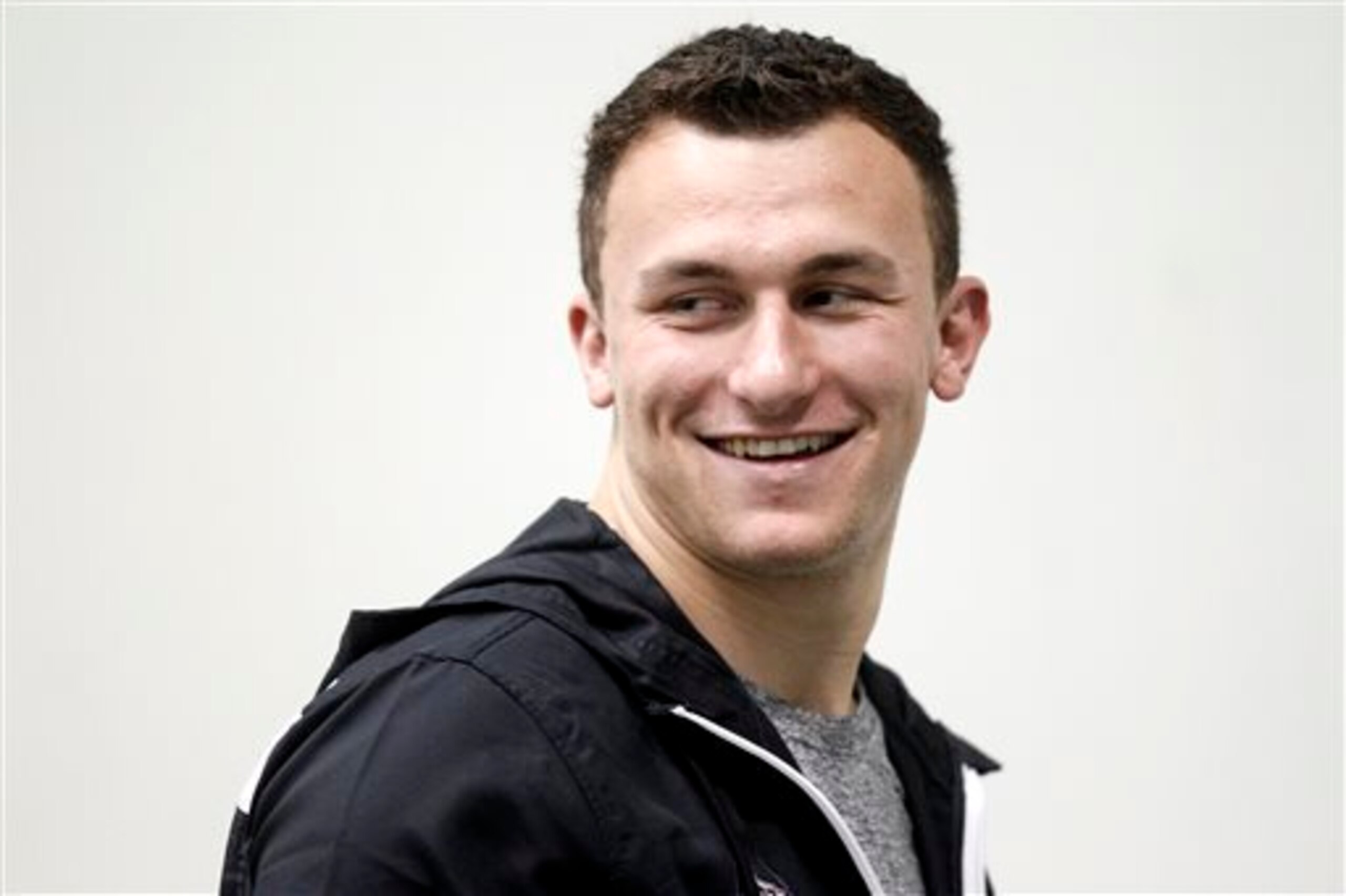 Texas A&M quarterback Johnny Manziel walks the field during Texas A&M's pro day Wednesday, March 5, 2014, in College Station, Texas. Manziel did not compete in the Pro Day.  (AP Photo/Patric Schneider)