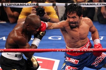 LAS VEGAS, NV - JUNE 09:  (R-L) Manny Pacquiao lands a right to the head of Timothy Bradley during their WBO welterweight title fight at MGM Grand Garden Arena on June 9, 2012 in Las Vegas, Nevada.  (Photo by Jeff Bottari/Getty Images)