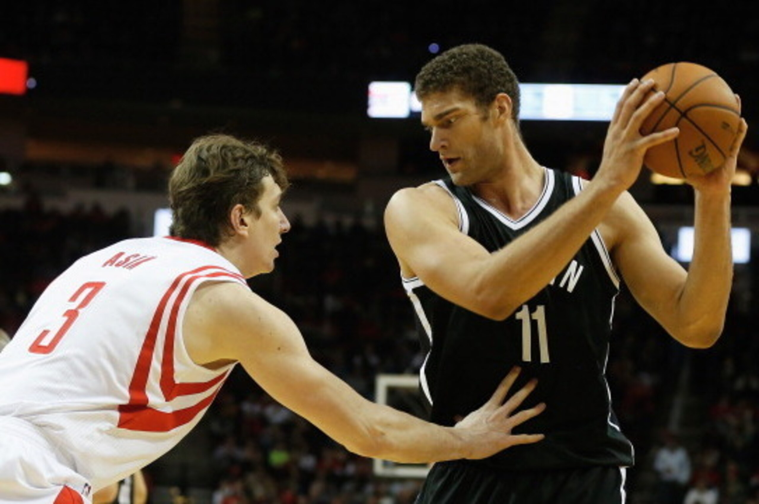 HOUSTON, TX - NOVEMBER 29:  Brook Lopez #11 of the Brooklyn Nets works the ball against Omer Asik #3 of the Houston Rockets during the game at Toyota Center on November 29, 2013 in Houston, Texas. NOTE TO USER: User expressly acknowledges and agrees that,