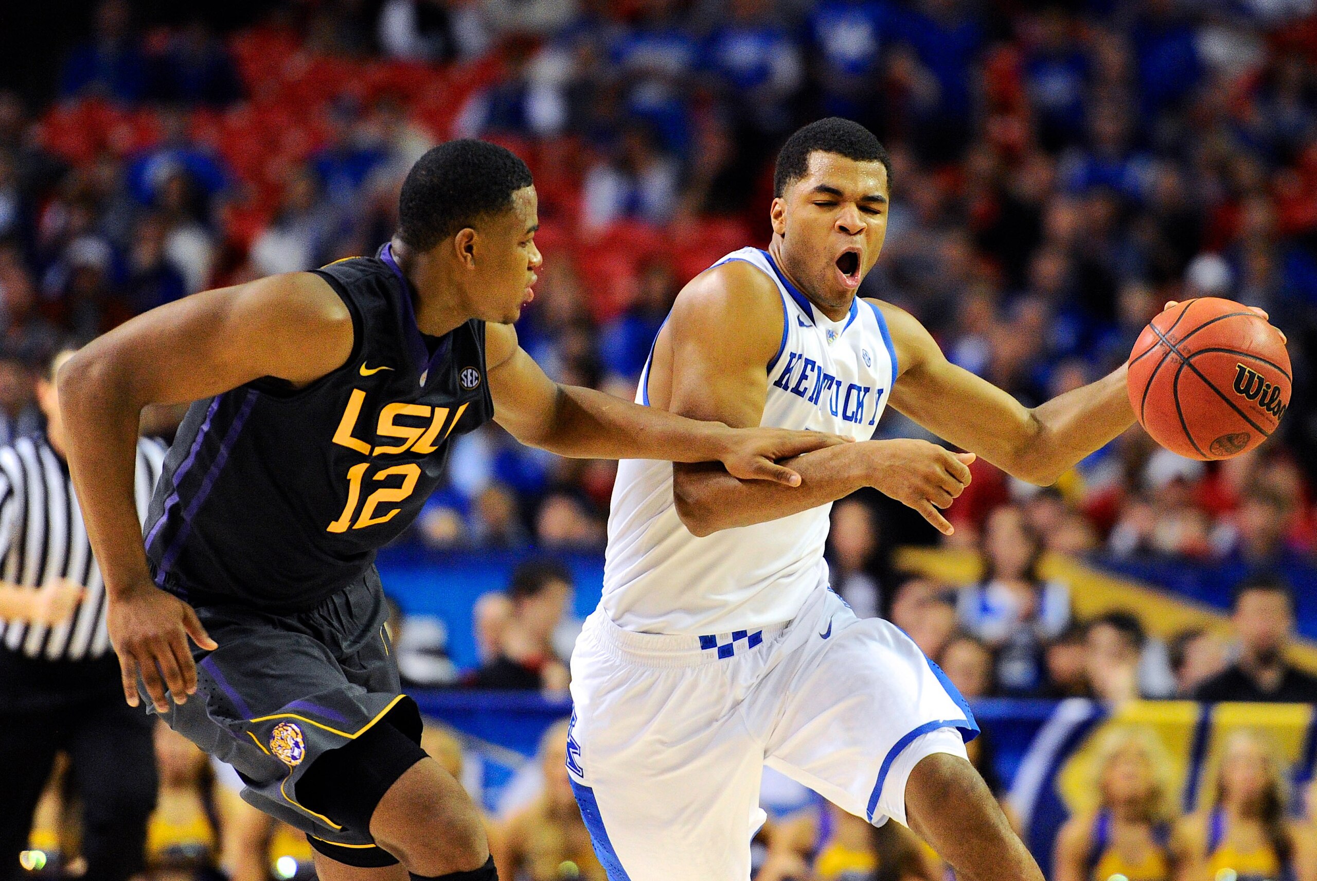Mar 14, 2014; Atlanta, GA, USA; Kentucky Wildcats guard Andrew Harrison (5) brings the ball up court against LSU Tigers forward Jarell Martin (12) during the second half in the quarterfinals of the SEC college basketball tournament at Georgia Dome. Kentuc
