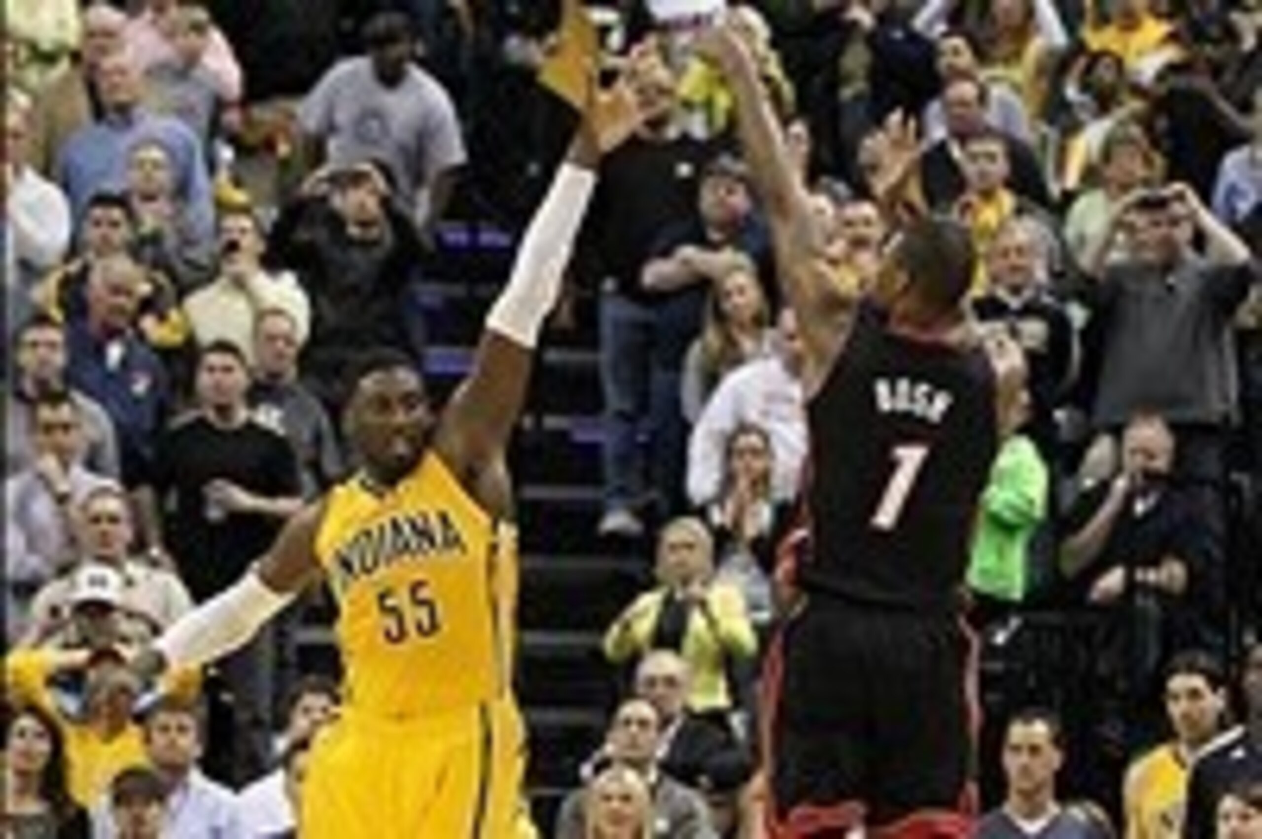Mar 26, 2014; Indianapolis, IN, USA;  Miami Heat center Chris Bosh (1) takes the final shot of the game with Indiana Pacers center Roy Hibbert (55) defending during the fourth quarter at Bankers Life Fieldhouse. The Pacers won 84-83. Mandatory Credit: Pat