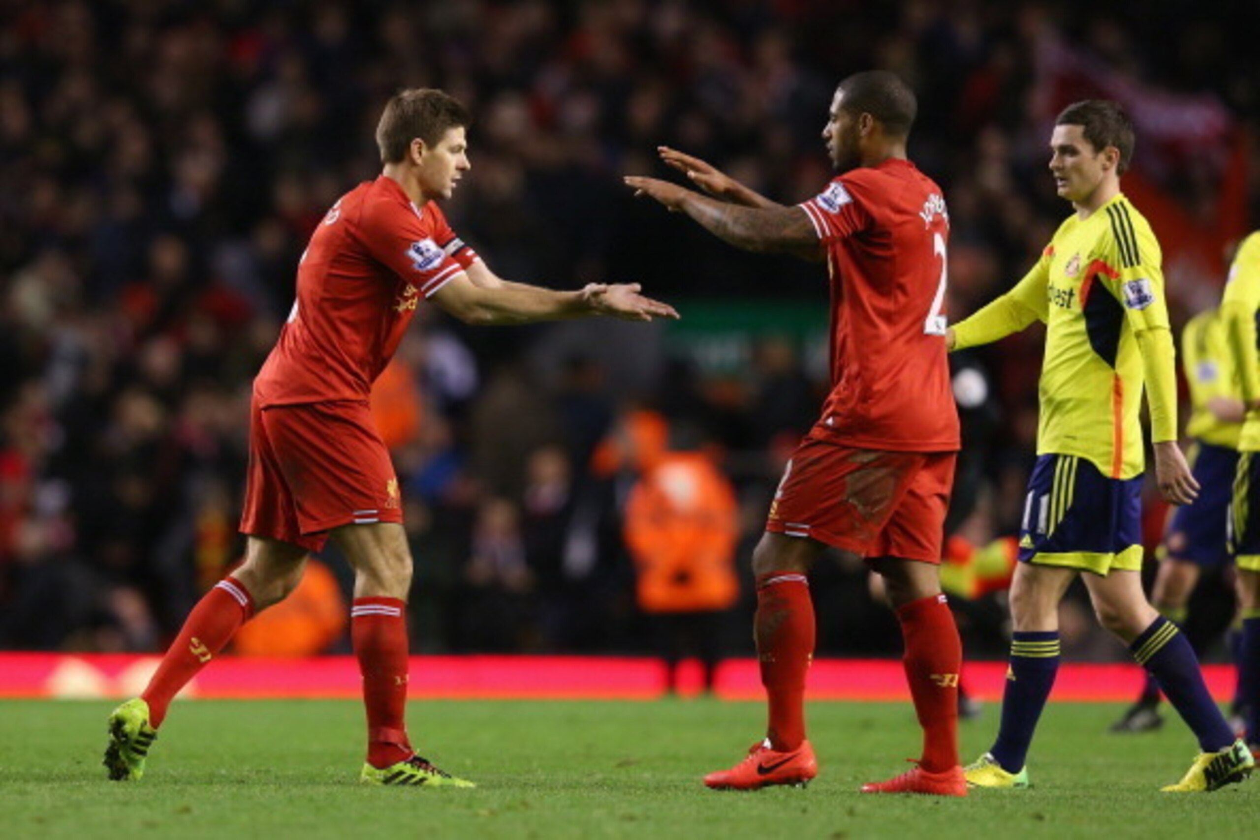 LIVERPOOL, ENGLAND - MARCH 26:  Steven Gerrard of Liverpool celebrates with team-mate Glen Johnson (R) at the end of the Barclays Premier League match between Liverpool and Sunderland at Anfield on March 26, 2014 in Liverpool, England.  (Photo by Alex Liv