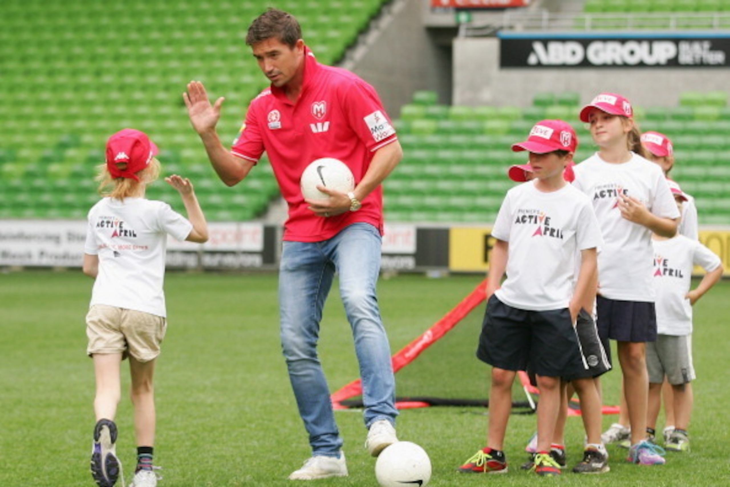 MELBOURNE, AUSTRALIA - MARCH 05:  Harry Kewell of the Melbourne Heart football team plays a game with children during the launch of 'Premier's Active April' at AAMI Park on March 5, 2014 in Melbourne, Australia. The program aims at promoting a healthy and