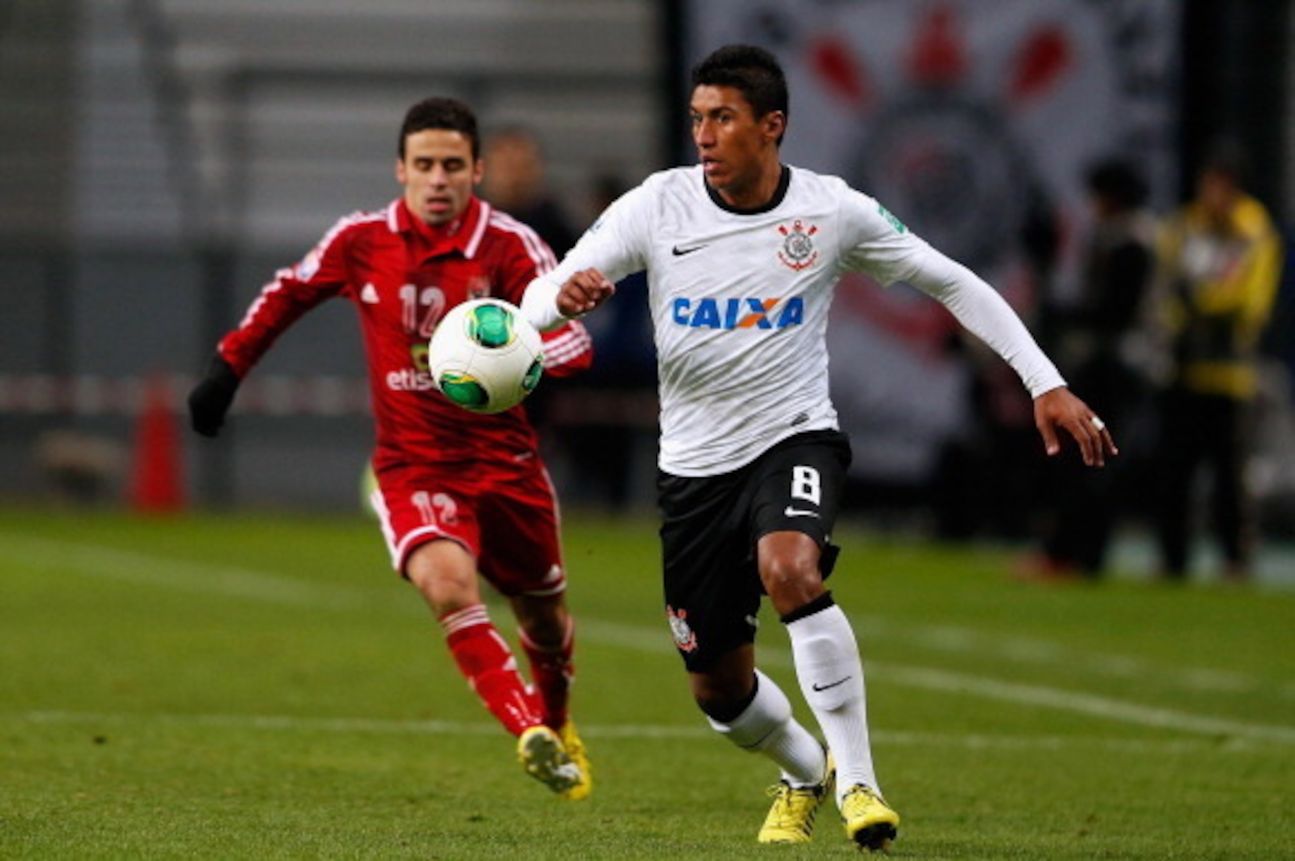 TOYOTA, JAPAN - DECEMBER 12:  Paulinho (R) of Corinthians challenges Ahmed Kenawi (L) of Al-Ahly SC during the FIFA Club World Cup Semi Final match between Al-Ahly SC and Corinthians at Toyota Stadium on December 12, 2012 in Toyota, Japan.  (Photo by Lint