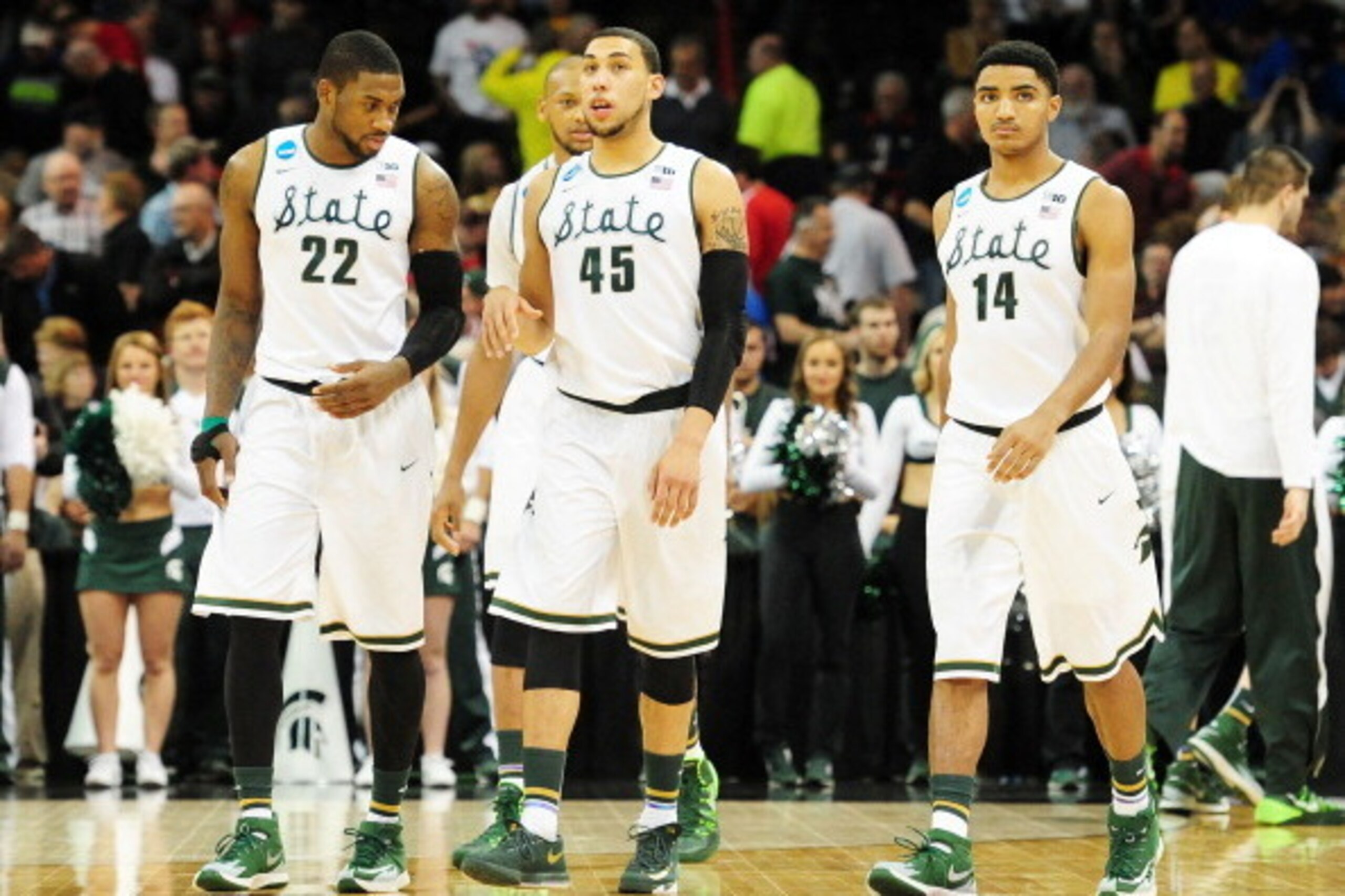 SPOKANE, WA - MARCH 22:  Branden Dawson #22 Adreian Payne #5 Denzel Valentine #45 and Gary Harris #14 of the Michigan State Spartans look on in the second half against the Harvard Crimson during the Third Round of the 2014 NCAA Basketball Tournament at Sp