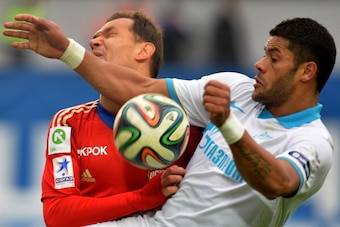 KHIMKI, RUSSIA - MARCH 15: Sergei Ignashevich (L) of PFC CSKA Moscow challenged by Hulk of FC Zenit St. Petersburg during the Russian Premier League match between PFC CSKA Moscow and FC Zenit St. Petersburg at the Arena Khimki Stadium on March 15, 2014 in
