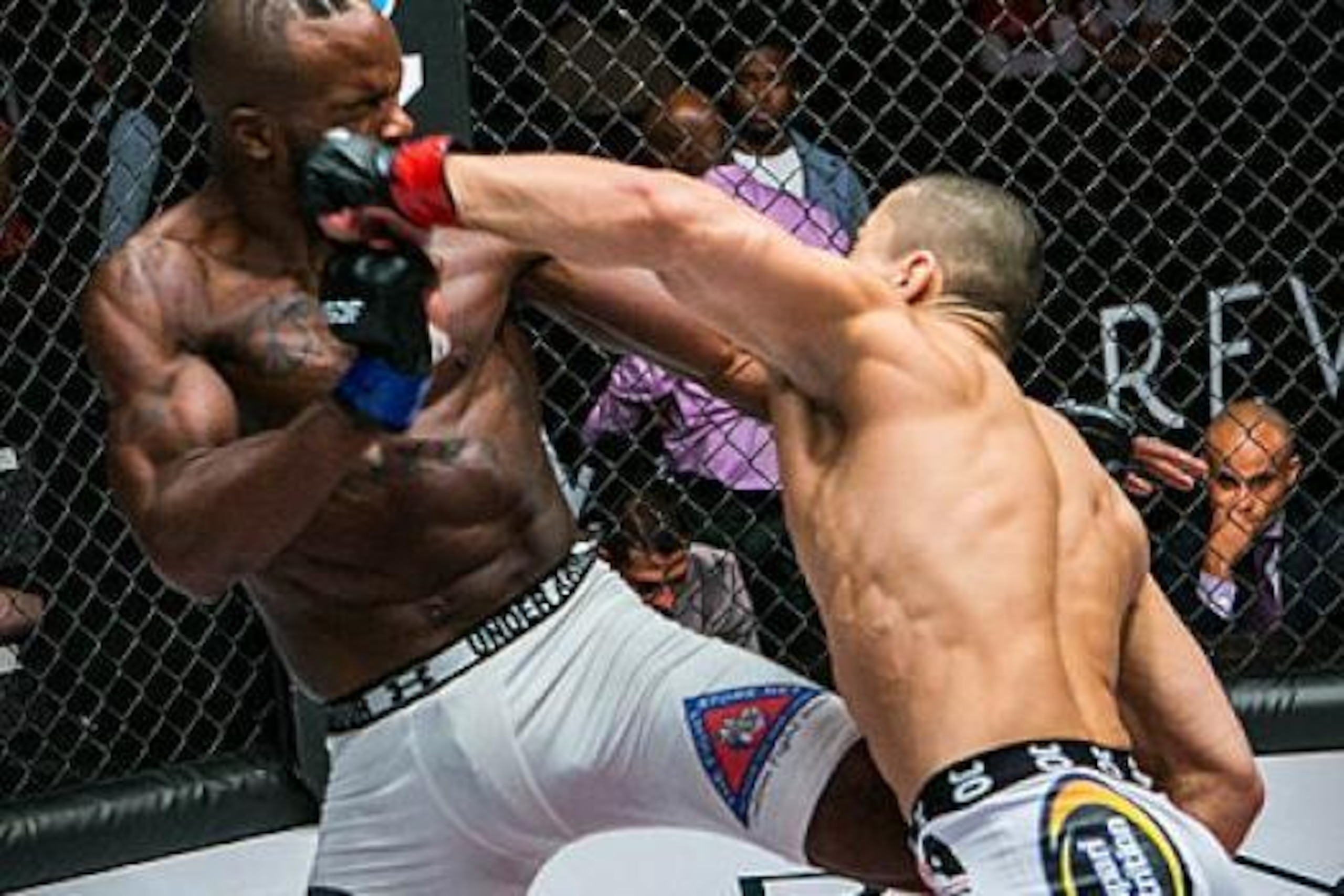 Dugulubgov (right) strikes Andrew Osborne in their recent fight.