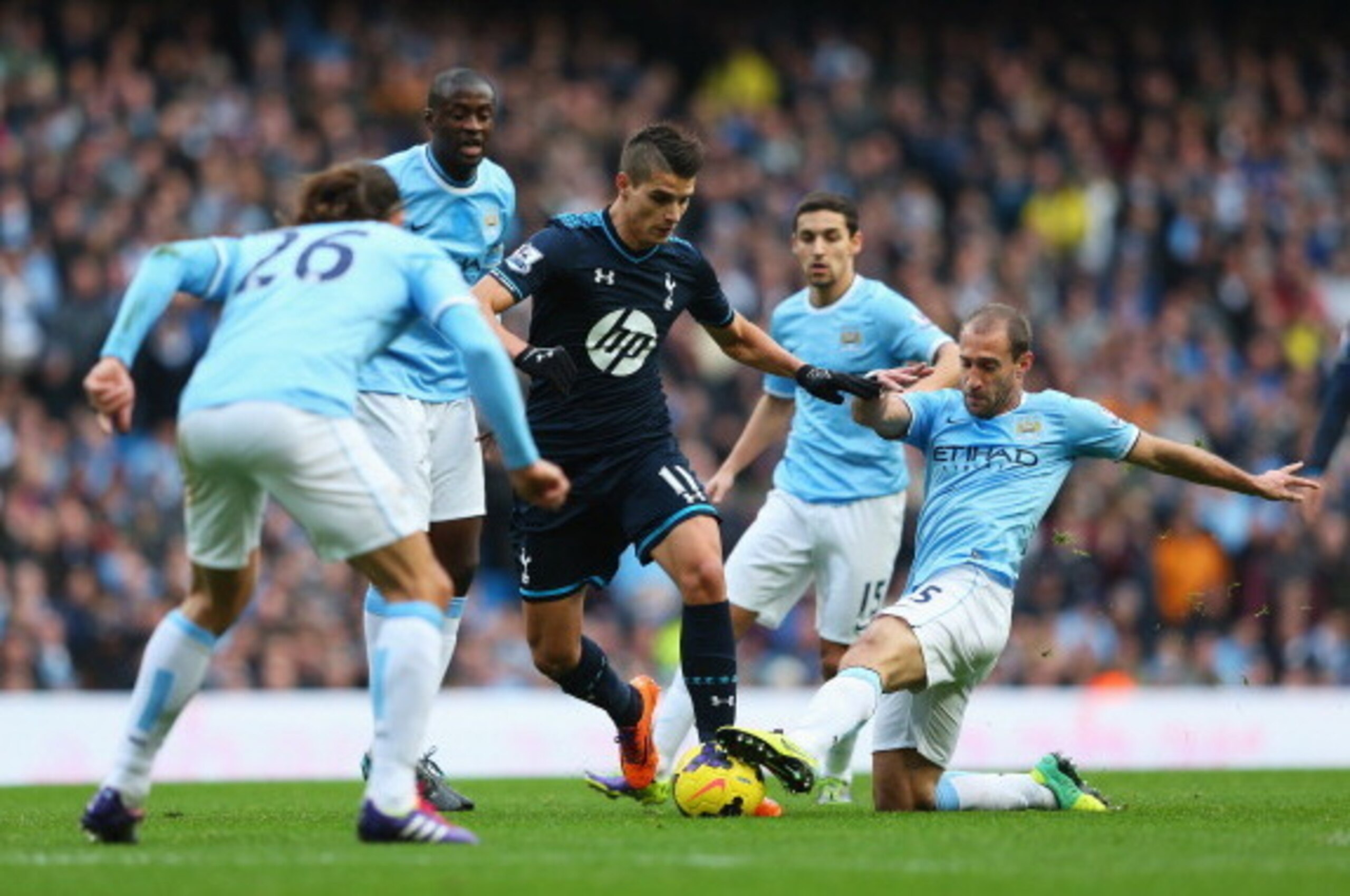 MANCHESTER, ENGLAND - NOVEMBER 24: Erik Lamela of Tottenham Hotspur is tackled by Pablo Zabaleta of Manchester City during the Barclays Premier League match between Manchester City and Tottenham Hotspur at Etihad Stadium on November 24, 2013 in Manchester