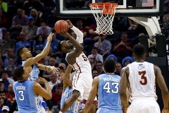 Mar 23, 2014; San Antonio, TX, USA; Iowa State Cyclones guard DeAndre Kane (50) shoots over North Carolina Tar Heels guard Nate Britt (0) and forward James Michael McAdoo (43) in the second half of a men's college basketball game during the third round of