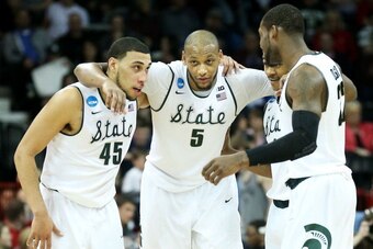 SPOKANE, WA - MARCH 22:  Denzel Valentine #45 Adreian Payne #5, Keith Appling #11 and Branden Dawson #22 of the Michigan State Spartans celebrate in the second half of their 80 to 73 win over the Harvard Crimson during the Third Round of the 2014 NCAA Bas