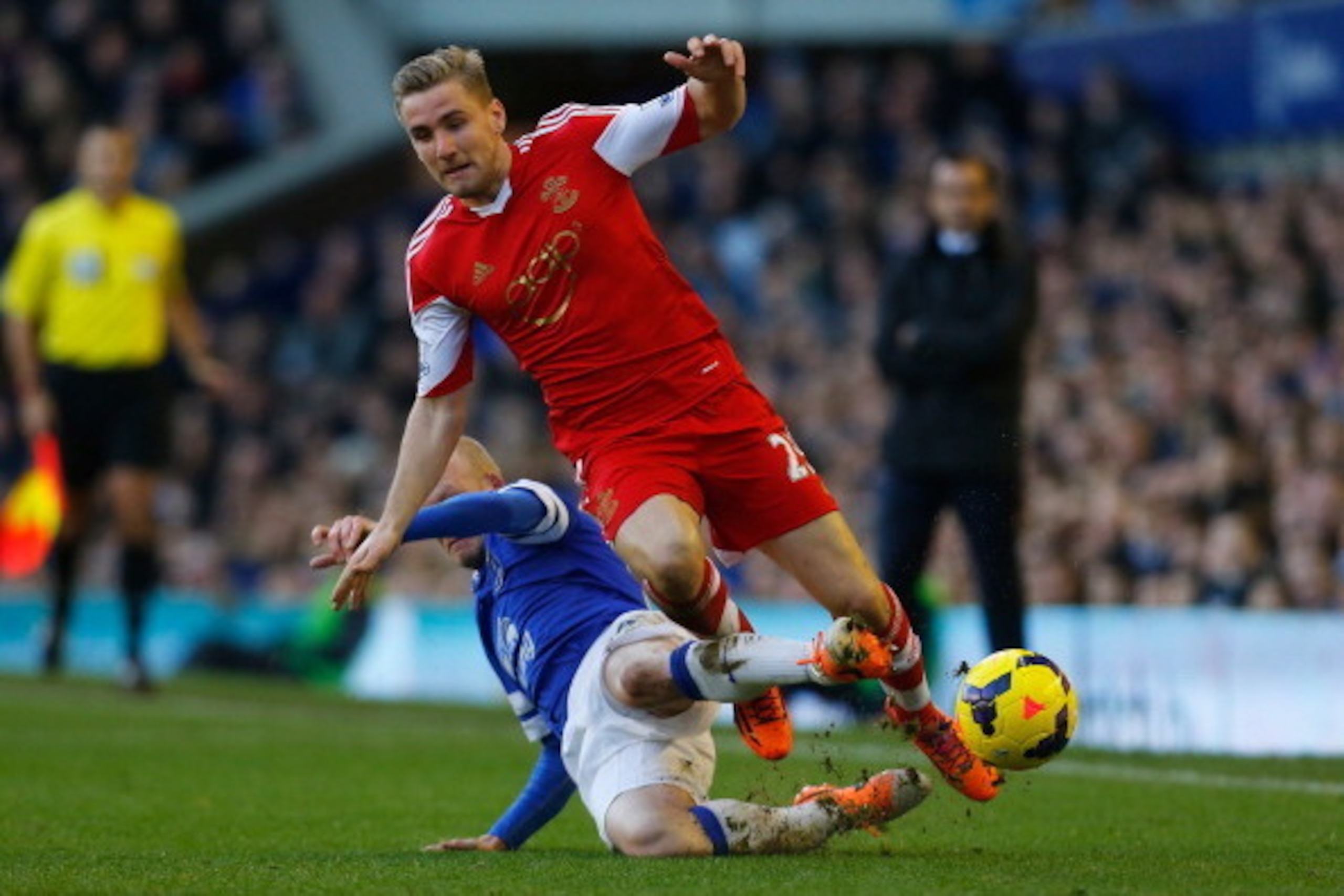 LIVERPOOL, ENGLAND - DECEMBER 29:  Luke Shaw of Southampton is tackled by Steven Naismith of Everton during the Barclays Premier League match between Everton and Southampton at Goodison Park on December 29, 2013 in Liverpool, England.  (Photo by Paul Thom