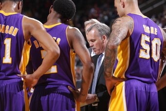 PORTLAND, OR - MARCH 3:  Mike D'Antoni of the Los Angeles Lakers draws up plays against the Portland Trail Blazers on March 3, 2014 at the Moda Center Arena in Portland, Oregon. NOTE TO USER: User expressly acknowledges and agrees that, by downloading and