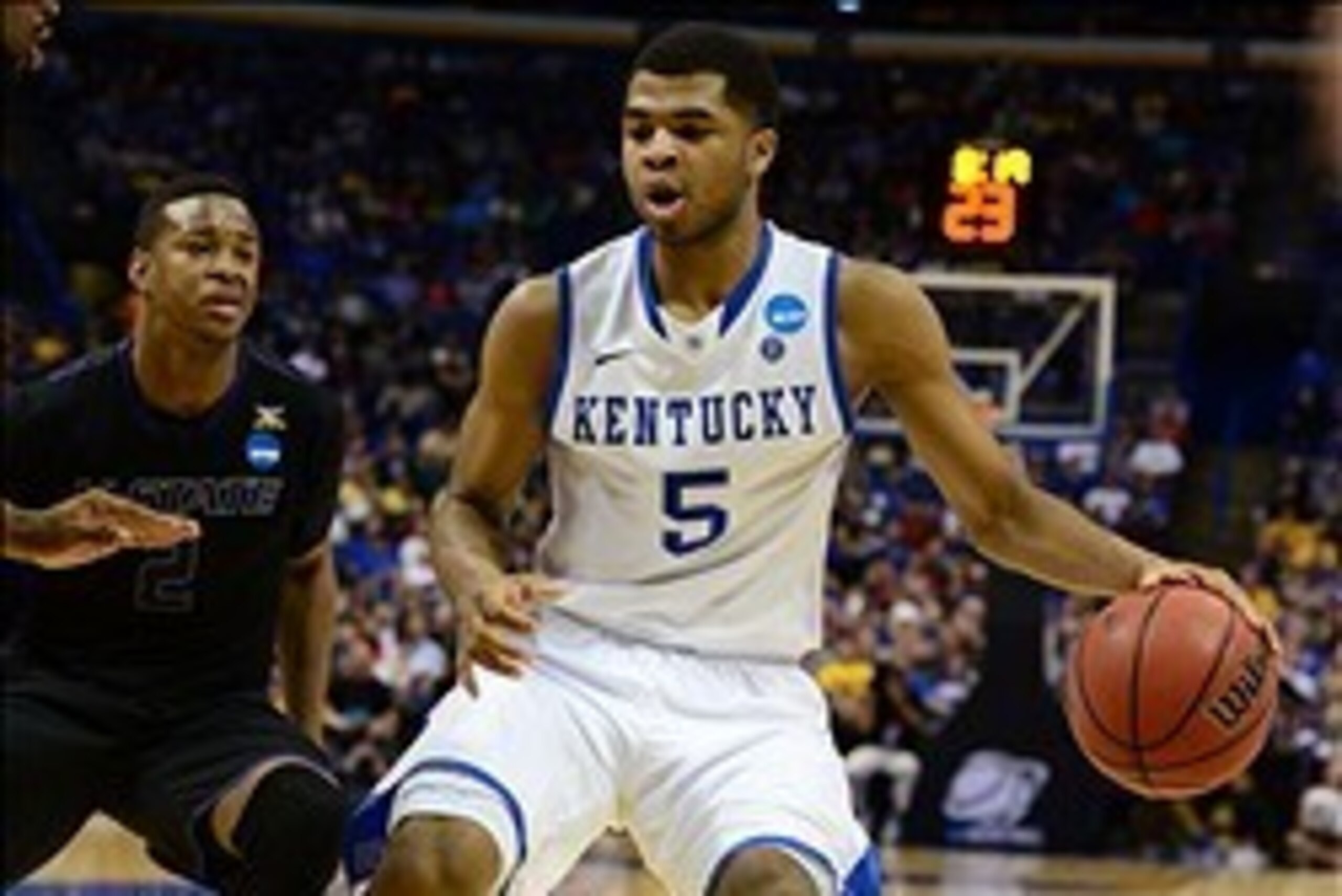 Mar 21, 2014; St. Louis, MO, USA; Kentucky Wildcats guard Andrew Harrison (5) dribbles past Kansas State Wildcats guard Marcus Foster (2) in the second half during the 2nd round of the 2014 NCAA Men's Basketball Championship at Scottrade Center. Mandatory