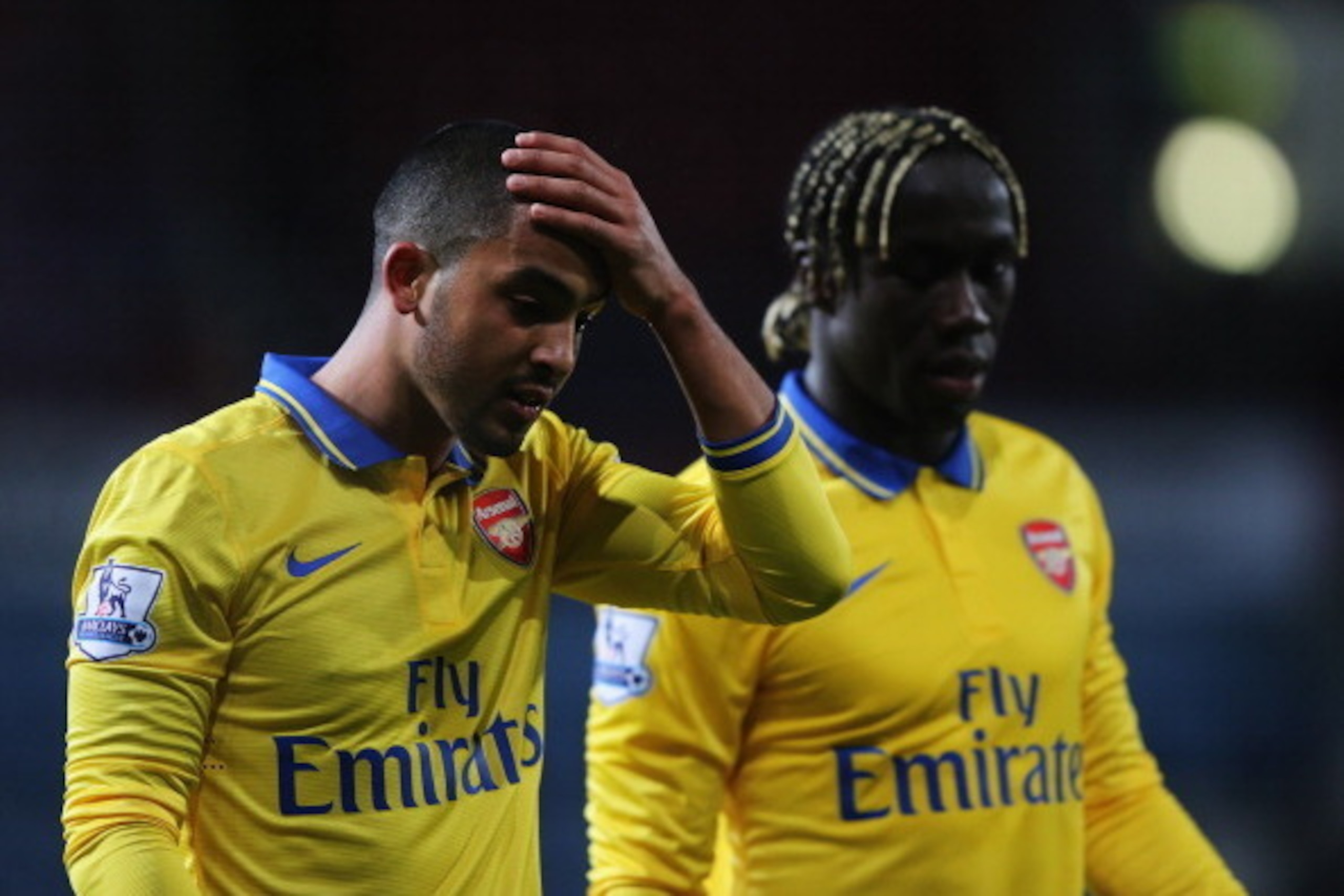 LONDON, ENGLAND - DECEMBER 26:  Theo Walcott (L) and Bacary Sagna of Arsenal look on after the Barclays Premier League match between West Ham United and Arsenal at Boleyn Ground on December 26, 2013 in London, England.  (Photo by Ian Walton/Getty Images)