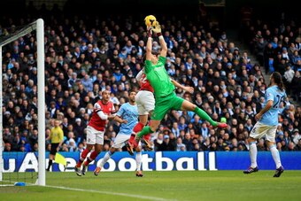 MANCHESTER, ENGLAND - DECEMBER 14:  Costel Pantilimon of Manchester City fails to hold onto a cross during the Barclays Premier League match between Manchester City and Arsenal at Etihad Stadium on December 14, 2013 in Manchester, England.  (Photo by Rich