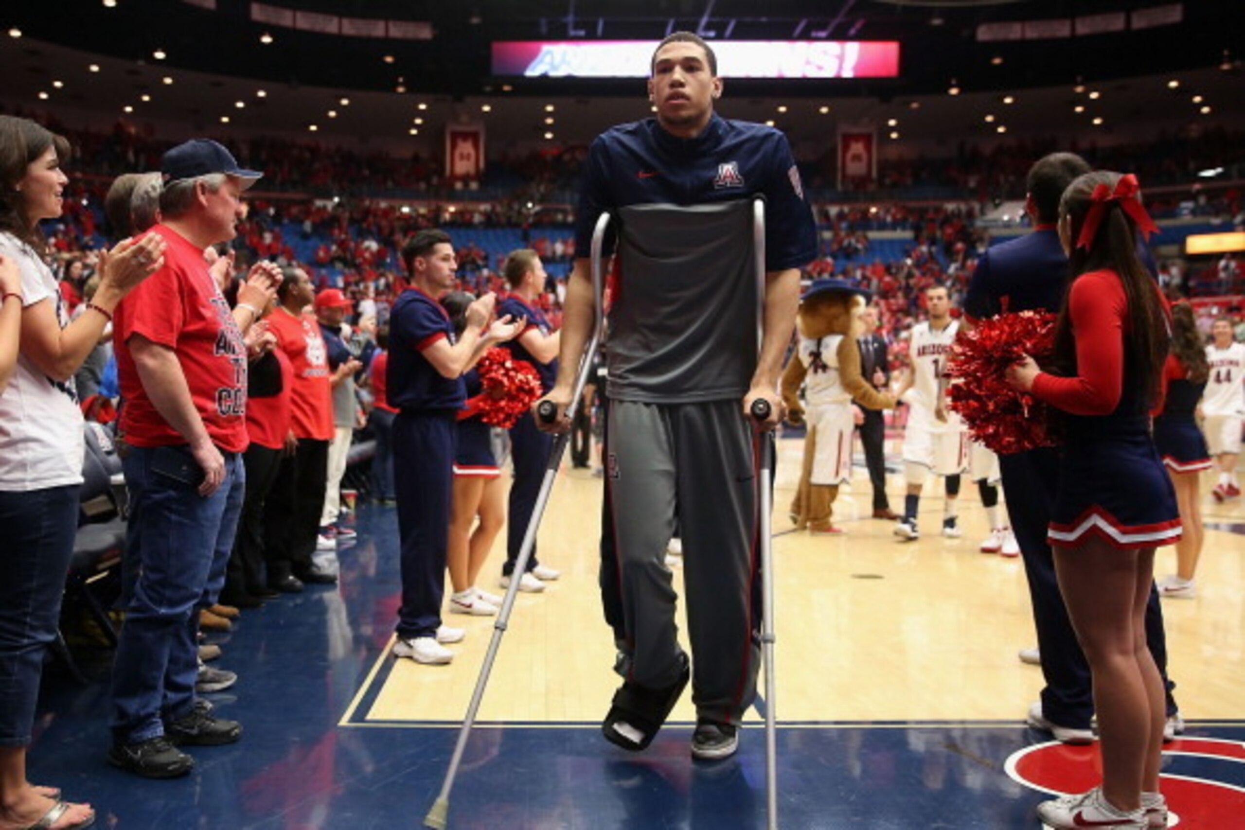 TUCSON, AZ - FEBRUARY 26:  Brandon Ashley #21 of the Arizona Wildcats walks off the court in crutches following the college basketball game against the California Golden Bears at McKale Center on February 26, 2014 in Tucson, Arizona.  The Wildcats defeate