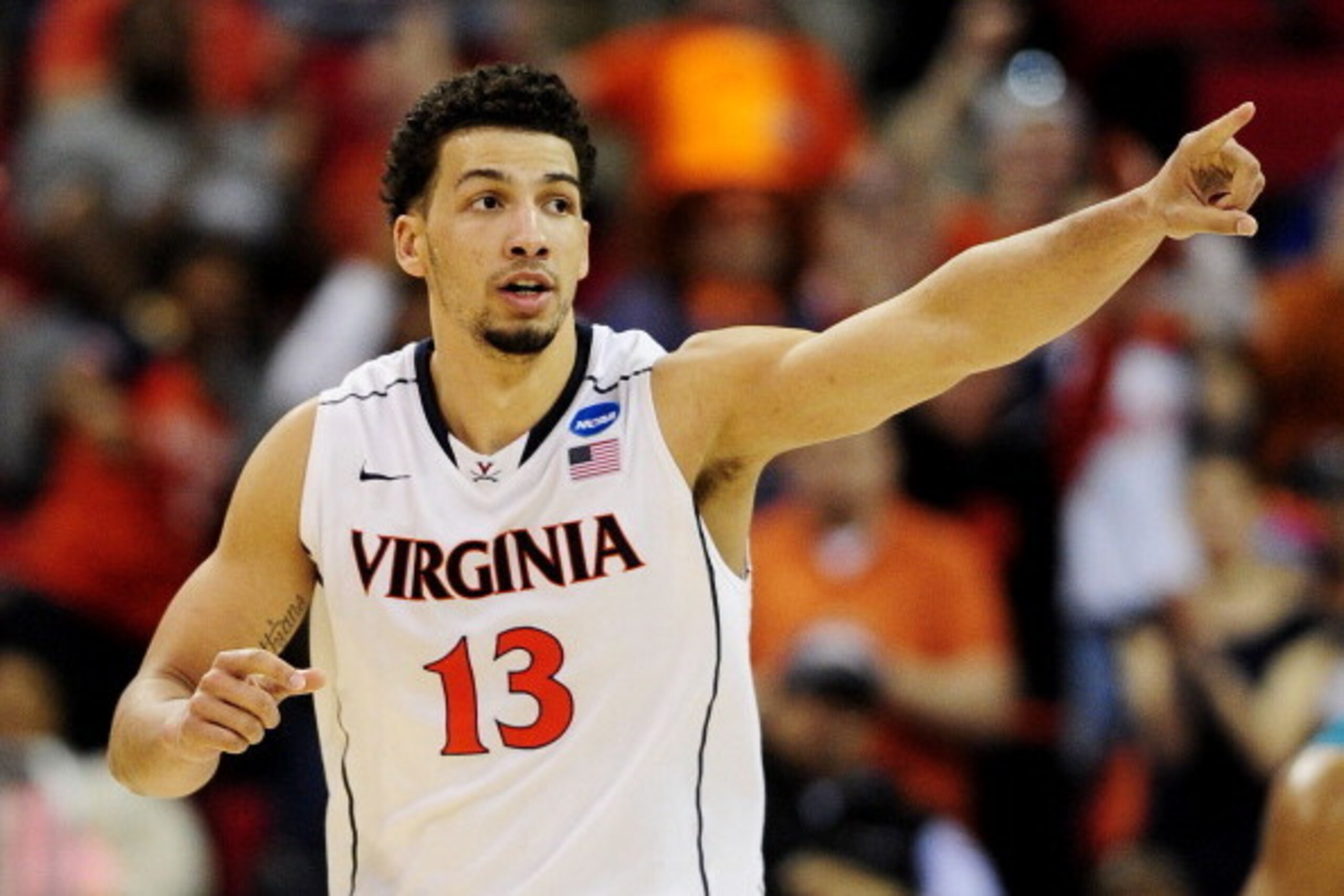 RALEIGH, NC - MARCH 21:  Anthony Gill #13 of the Virginia Cavaliers celebrates in their 70 to 59 win over the Coastal Carolina Chanticleers during the Second Round of the 2014 NCAA Basketball Tournament at PNC Arena on March 21, 2014 in Raleigh, North Car