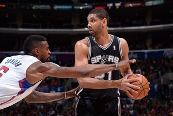 LOS ANGELES, CA - FEBRUARY 18: Tim Duncan #21 of the San Antonio Spurs handles the ball against DeAndre Jordan #6 of the Los Angeles Clippers at STAPLES Center on February 18, 2014 in Los Angeles, California. NOTE TO USER: User expressly acknowledges and 