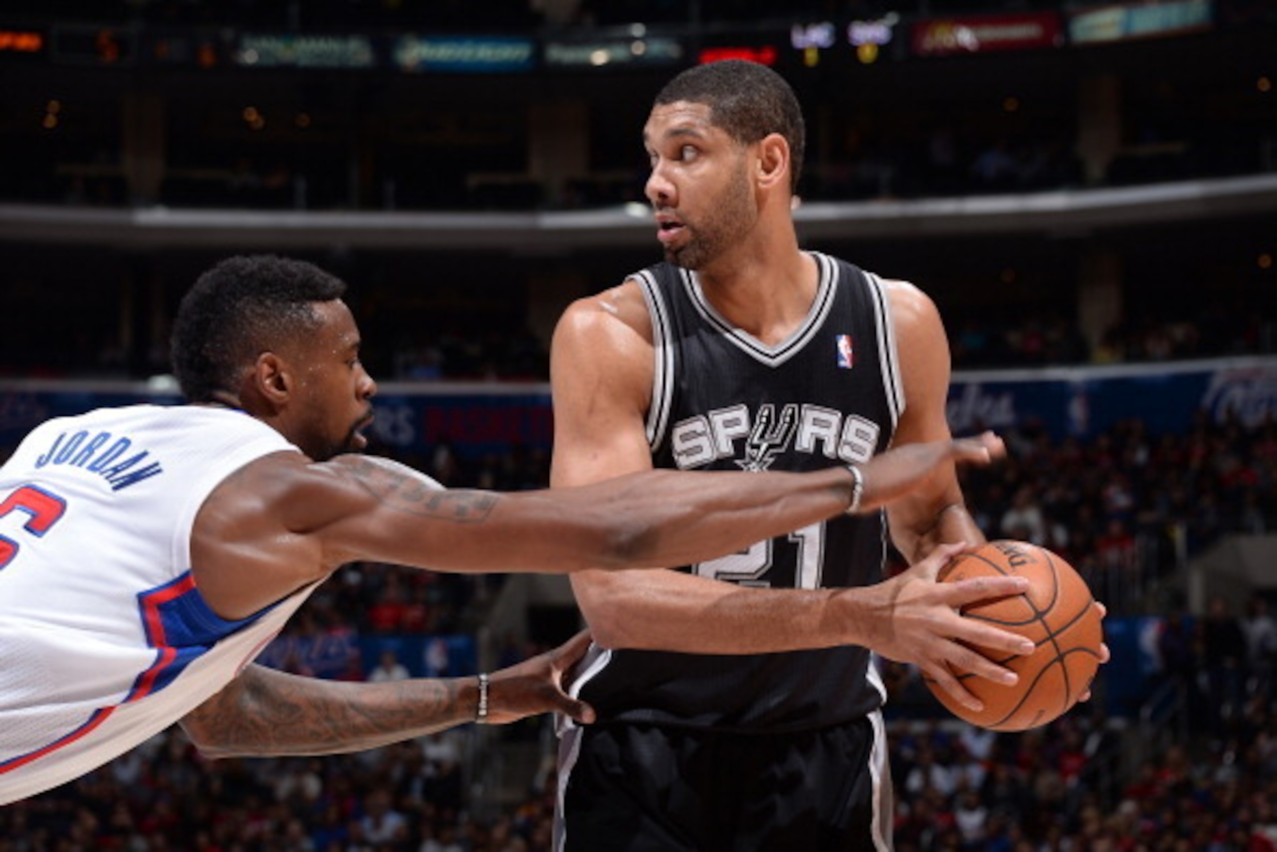 LOS ANGELES, CA - FEBRUARY 18: Tim Duncan #21 of the San Antonio Spurs handles the ball against DeAndre Jordan #6 of the Los Angeles Clippers at STAPLES Center on February 18, 2014 in Los Angeles, California. NOTE TO USER: User expressly acknowledges and 