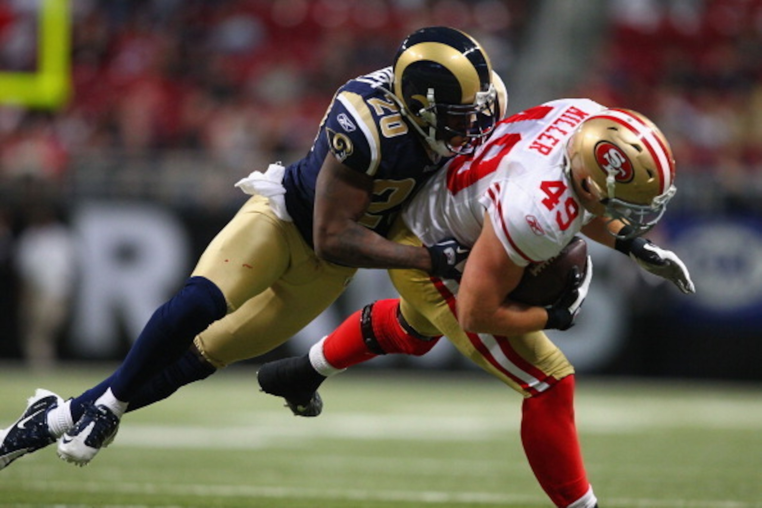 ST. LOUIS, MO - JANUARY 1: Darian Stewart #20 of the St. Louis Rams tackles Bruce Miller #49 of the San Francisco 49ers at the Edward Jones Dome on January 1, 2012 in St. Louis, Missouri.  The 49ers beat the Rams 34-27.  (Photo by Dilip Vishwanat/Getty Im