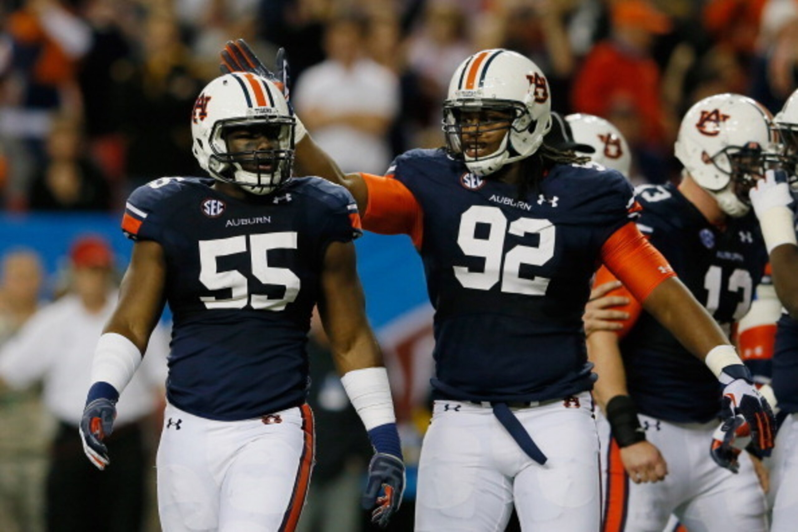 ATLANTA, GA - DECEMBER 07:  Carl Lawson #55 of the Auburn Tigers celebrates a sack with teammate Kenneth Carter #92 in the second quarter against the Missouri Tigers during the SEC Championship Game at Georgia Dome on December 7, 2013 in Atlanta, Georgia.