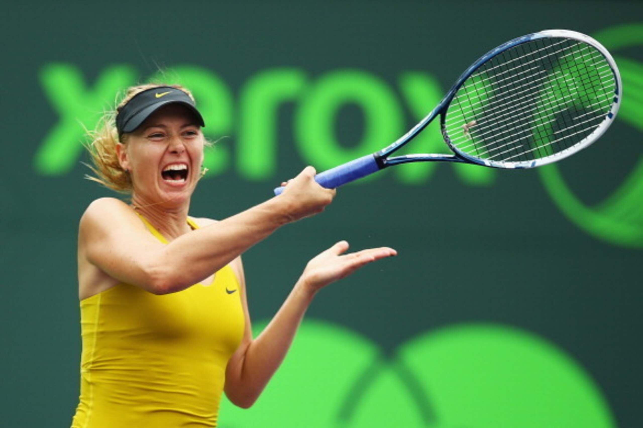 KEY BISCAYNE, FL - MARCH 24:  Maria Sharapova of Russia retuns a shot to Kirsten Flipkens of Belgium during their match on day 8 of the Sony Open at Crandon Park Tennis Center on March 24, 2014 in Key Biscayne, Florida.  (Photo by Al Bello/Getty Images)