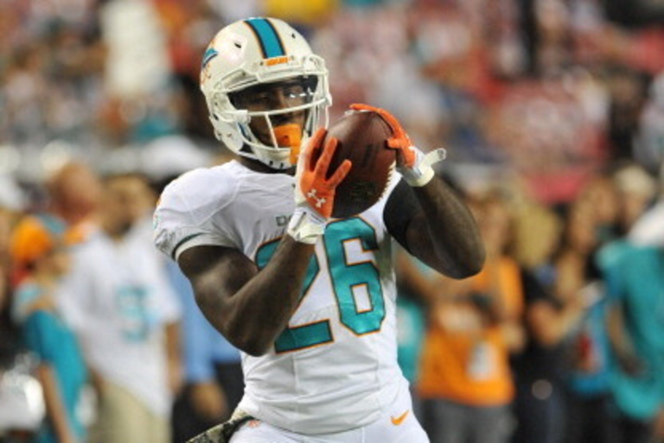 TAMPA, FL - NOVEMBER 11:  Running back Lamar Miller #26 of the Miami Dolphins grabs a warmup pass before play against the Tampa Bay Buccaneers November 11, 2013 at Raymond James Stadium in Tampa, Florida. (Photo by Al Messerschmidt/Getty Images)