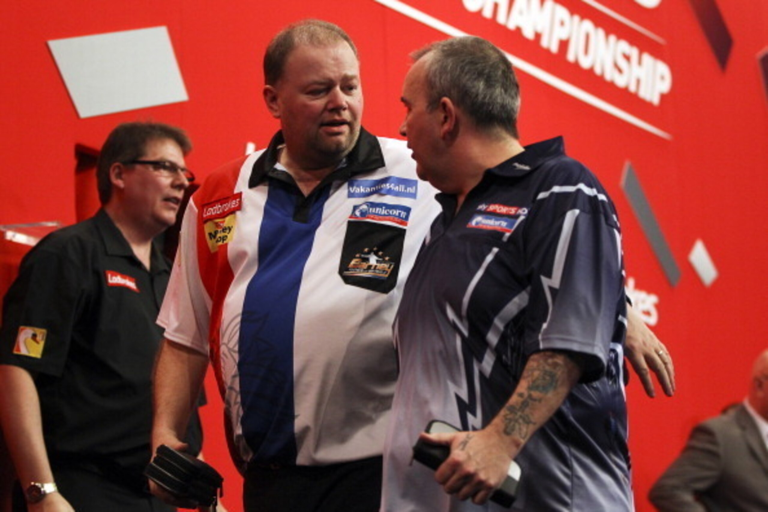 LONDON, ENGLAND - DECEMBER 30: Raymond van Barneveld of the Netherlands and Phil Taylor of England clash during their semi final match on day fourteen of the 2013 Ladbrokes.com World Darts Championship at the Alexandra Palace on December 30, 2012 in Londo