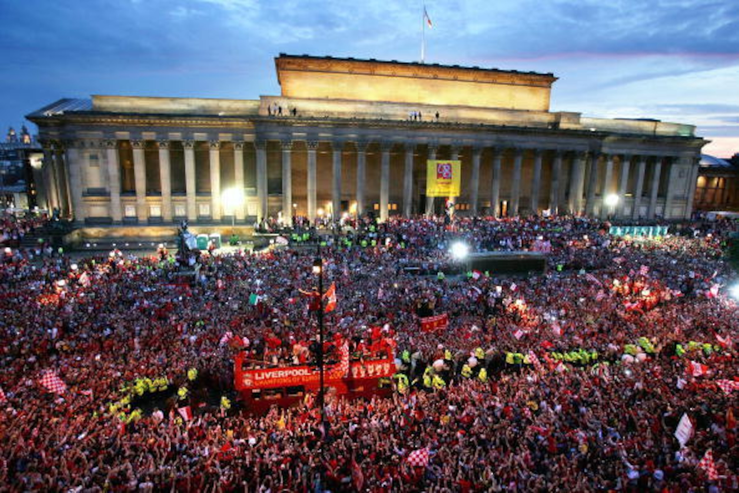 LIVERPOOL, ENGLAND - MAY 26:  The Liverpool team rides on an open top bus through a mass of fans as they arrive at St. George's Hall during the Liverpool Champions League Victory Parade on May 26, 2005 in Liverpool, England. Over 250,000 cheering fans hav