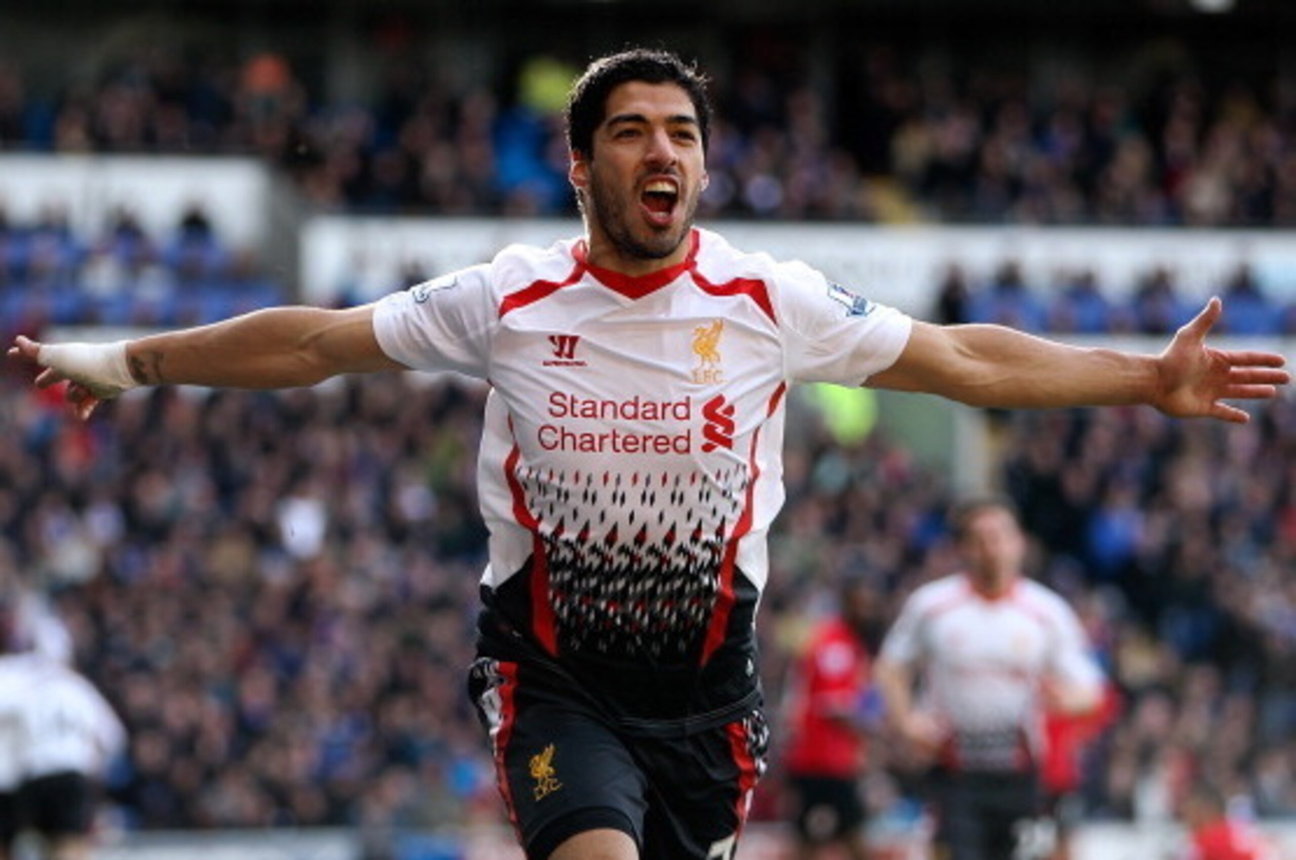 CARDIFF, WALES - MARCH 22:  Luis Suarez of Liverpool celebrates after scoring his team's fourth goal of the game during the Barclays Premier League match between Cardiff City and Liverpool at Cardiff City Stadium on March 22, 2014 in Cardiff, Wales.  (Pho