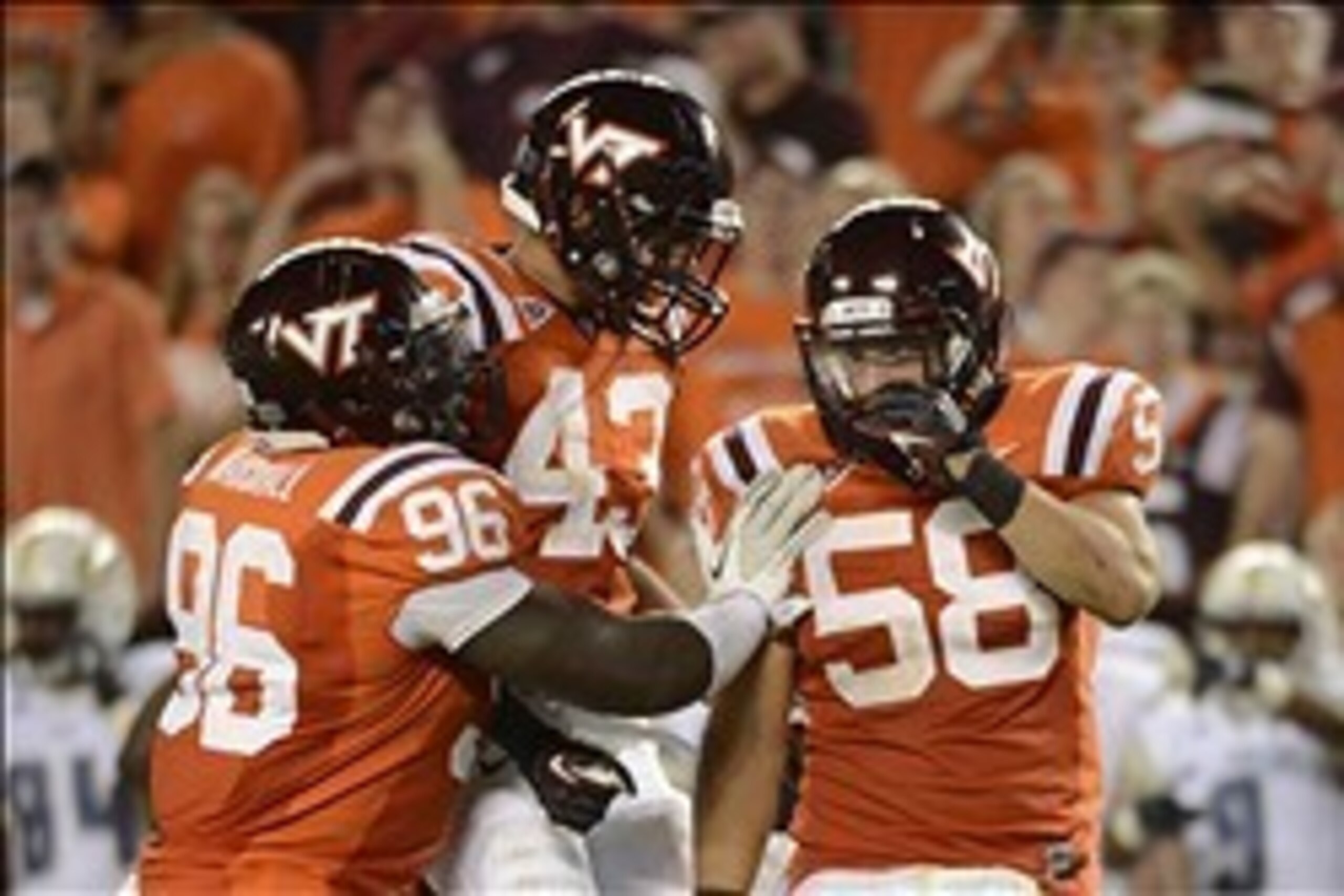 Spt 3, 2012; Blacksburg, VA, USA; Virginia Tech Hokies defensive end Corey Marshall (96) and linebackers Jeron Gouveia-Winslow (43) and Jack Tyler (58) celebrate in the fourth quarter. The Hokies defeated the Yellow Jackets 20-17 in overtime at Lane Stadi