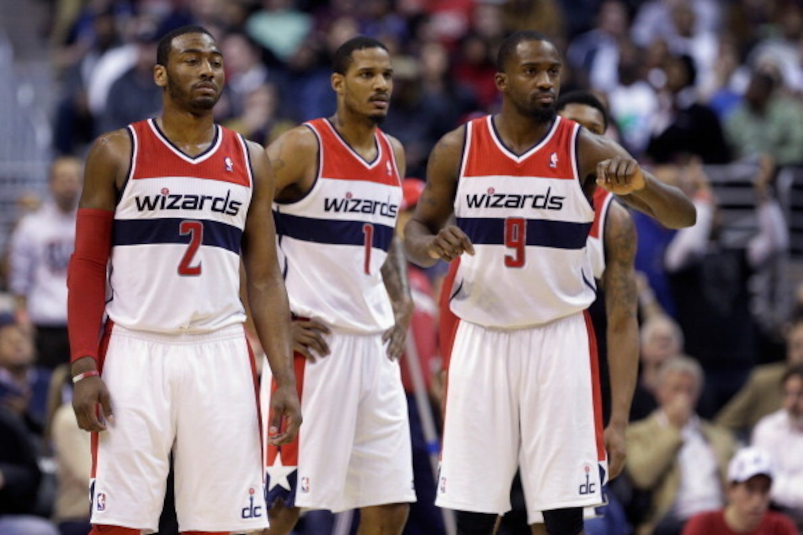 WASHINGTON, DC - FEBRUARY 27: John Wall #2, Trevor Ariza #1, and Martell Webster #9 of the Washington Wizards wait for the end of a timeout during the second half of the Wizards 96-95 loss to the Detroit Pistons at Verizon Center on February 27, 2013 in W