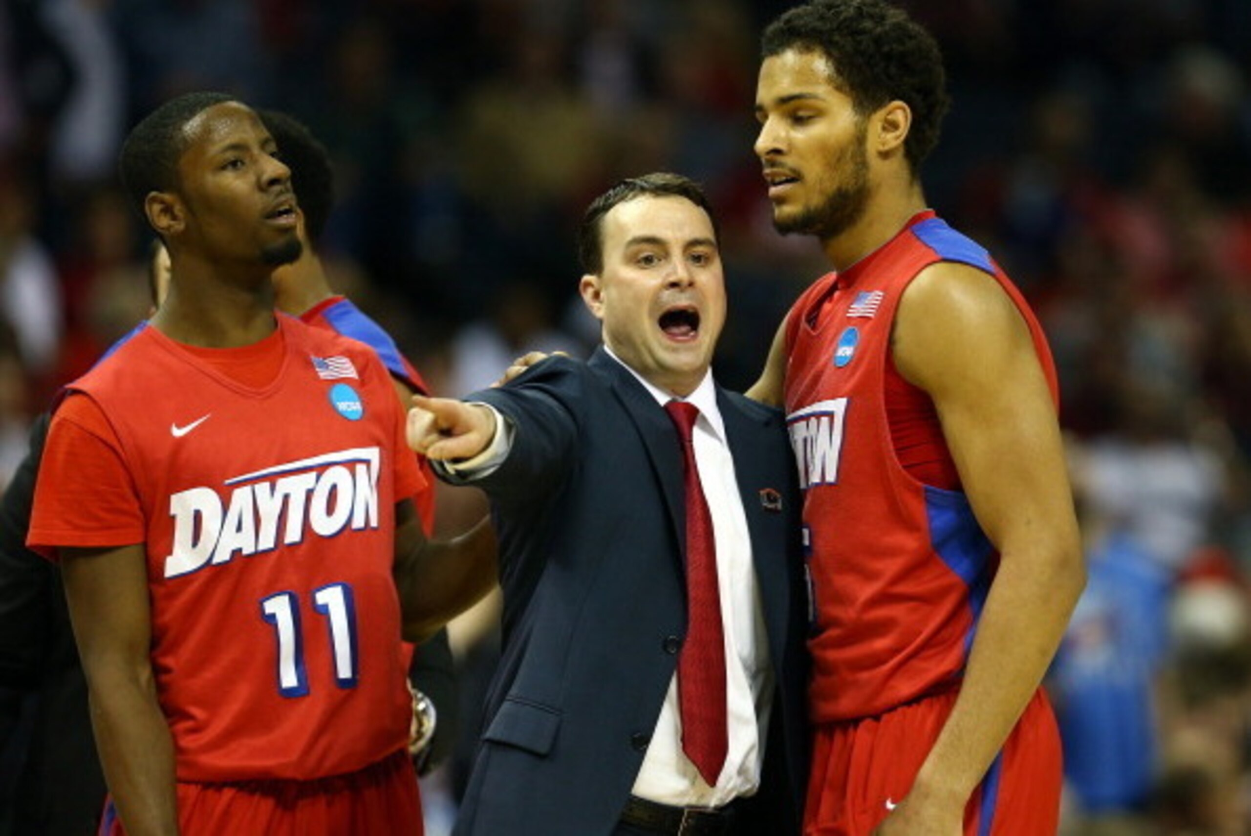 MEMPHIS, TN - MARCH 27: Head coach Archie Miller speaks with Devin Oliver #5 of the Dayton Flyers during a regional semifinal of the 2014 NCAA Men's Basketball Tournament against the Stanford Cardinal at the FedExForum on March 27, 2014 in Memphis, Tennes