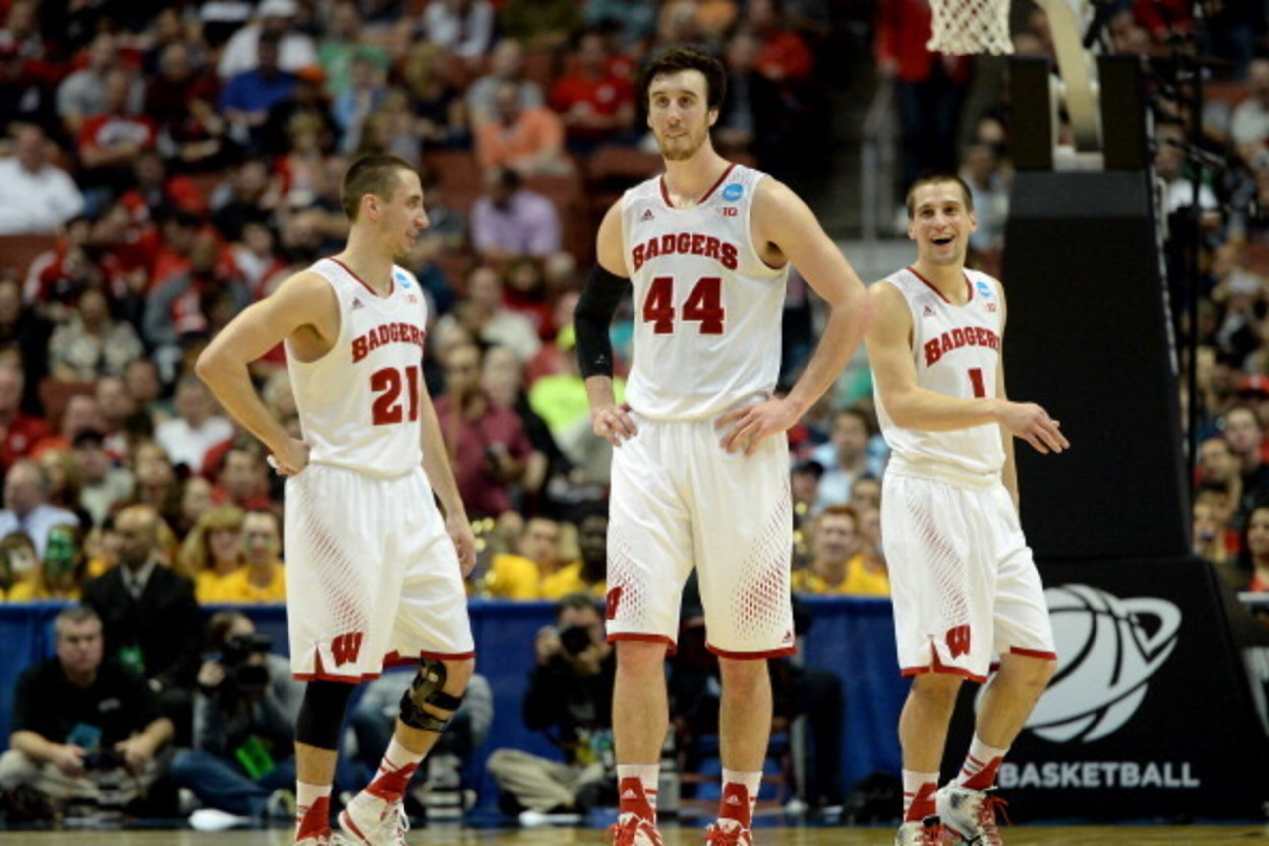 ANAHEIM, CA - MARCH 27:  Josh Gasser #21, Frank Kaminsky #44 and Ben Brust #1 of the Wisconsin Badgers celebrate in the second half while taking on the Baylor Bears during the regional semifinal of the 2014 NCAA Men's Basketball Tournament at the Honda Ce