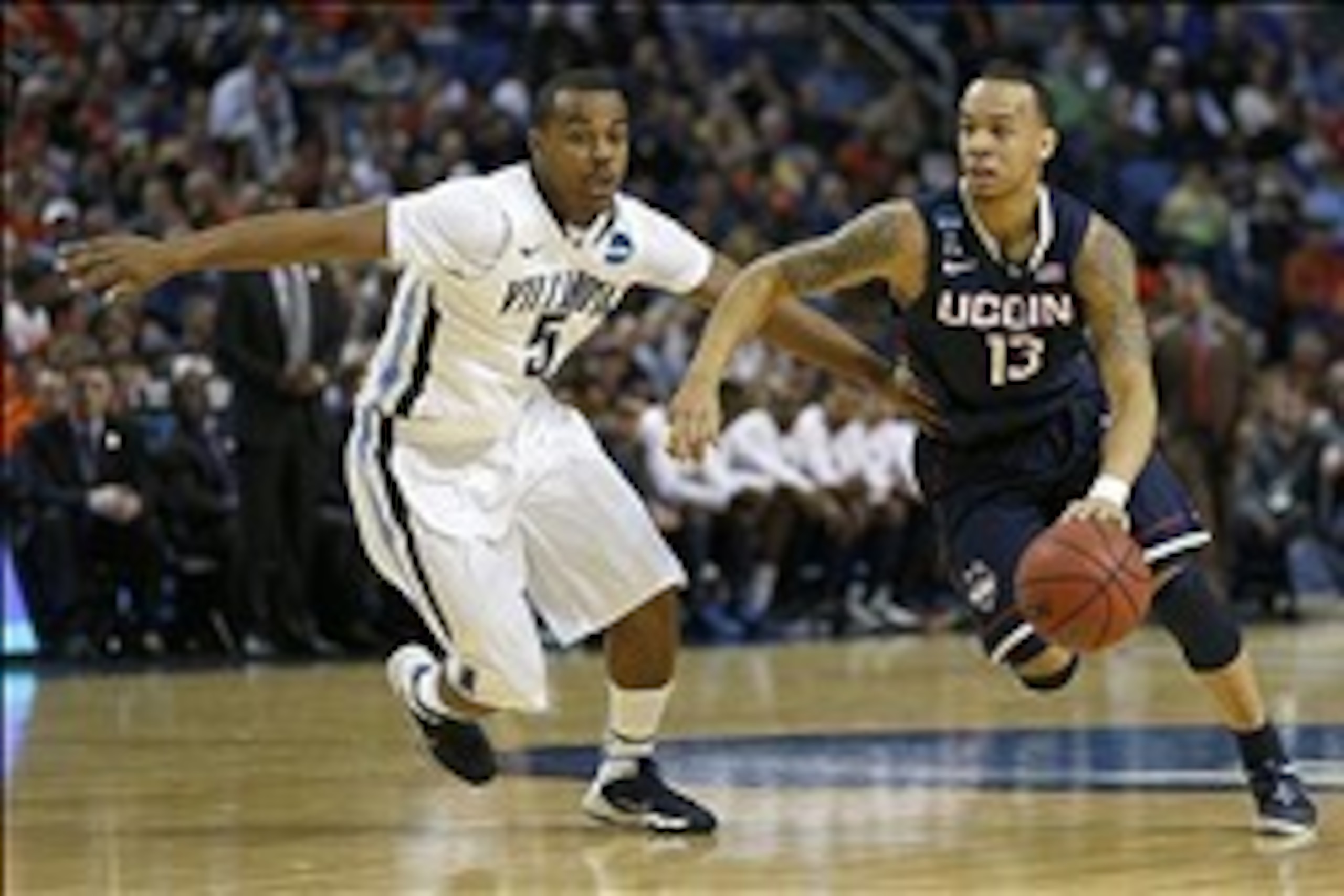 Mar 22, 2014; Buffalo, NY, USA; Connecticut Huskies guard Shabazz Napier (13) drives past Villanova Wildcats guard Tony Chennault (5) in the first half of a men's college basketball game during the third round of the 2014 NCAA Tournament at First Niagara Mar 22, 2014; Buffalo, NY, USA; Connecticut Huskies guard Shabazz Napier (13) drives past Villanova Wildcats guard Tony Chennault (5) in the first half of a men's college basketball game during the third round of the 2014 NCAA Tournament at First Niagara