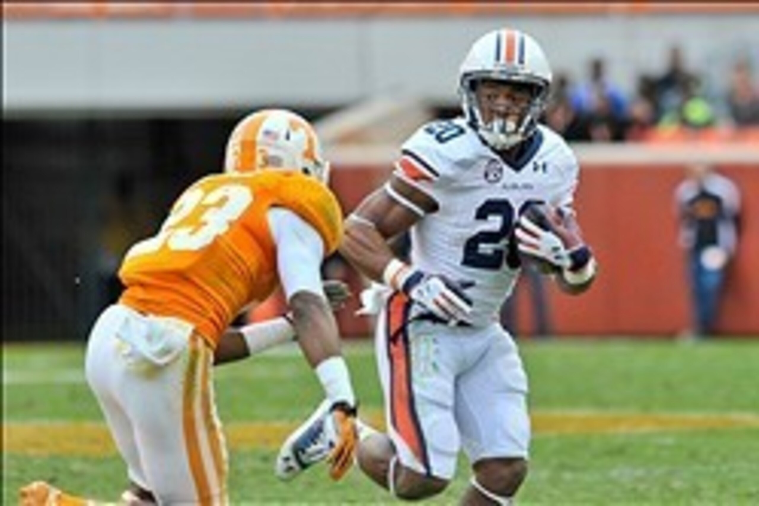 Nov 9, 2013; Knoxville, TN, USA; Auburn Tigers running back Corey Grant (20) rushes against Tennessee Volunteers defensive back Cameron Sutton (23) during the second half at Neyland Stadium. Auburn won 55-23. Mandatory Credit: Jim Brown-USA TODAY Sports