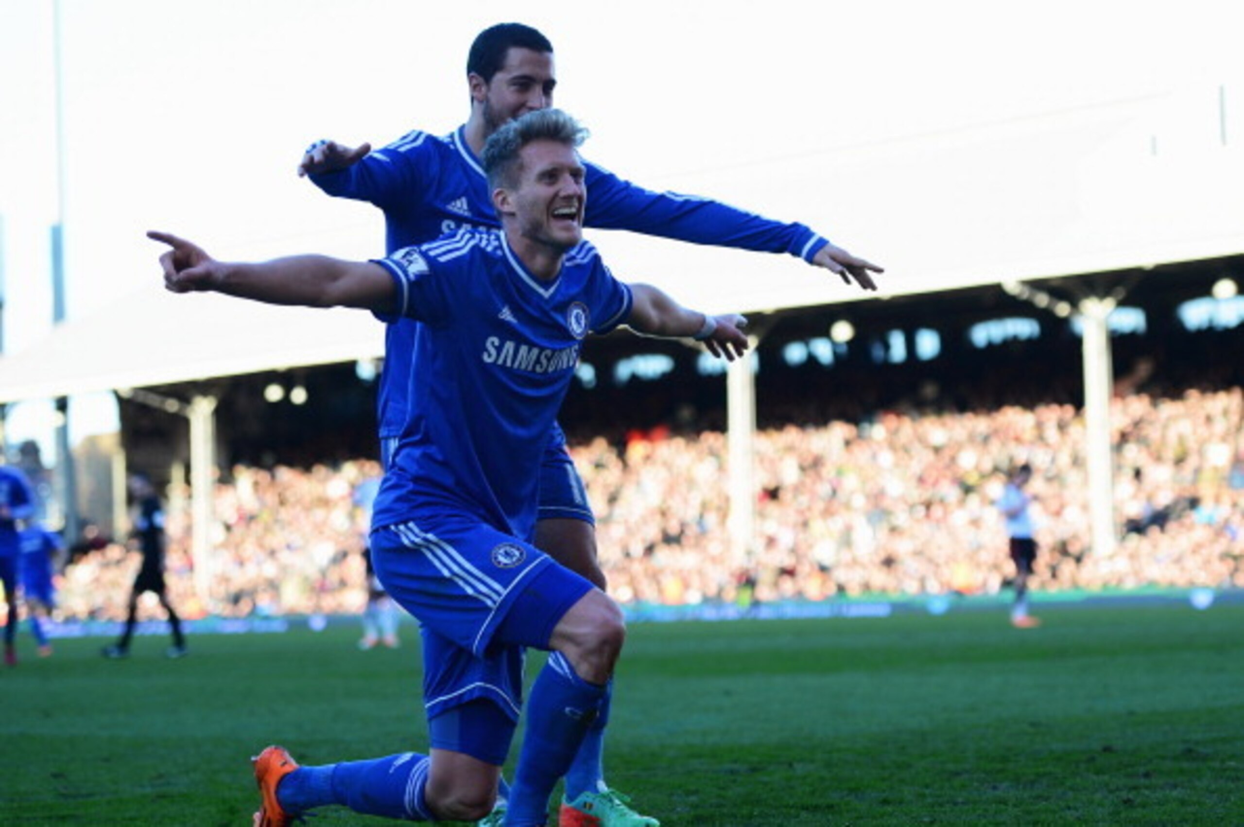LONDON, ENGLAND - MARCH 01:  Andre Schurrle of Chelsea celebrates with Eden Hazard as he scores their third goal and completes his hat trick during the Barclays Premier League match between Fulham and Chelsea at Craven Cottage on March 1, 2014 in London, 