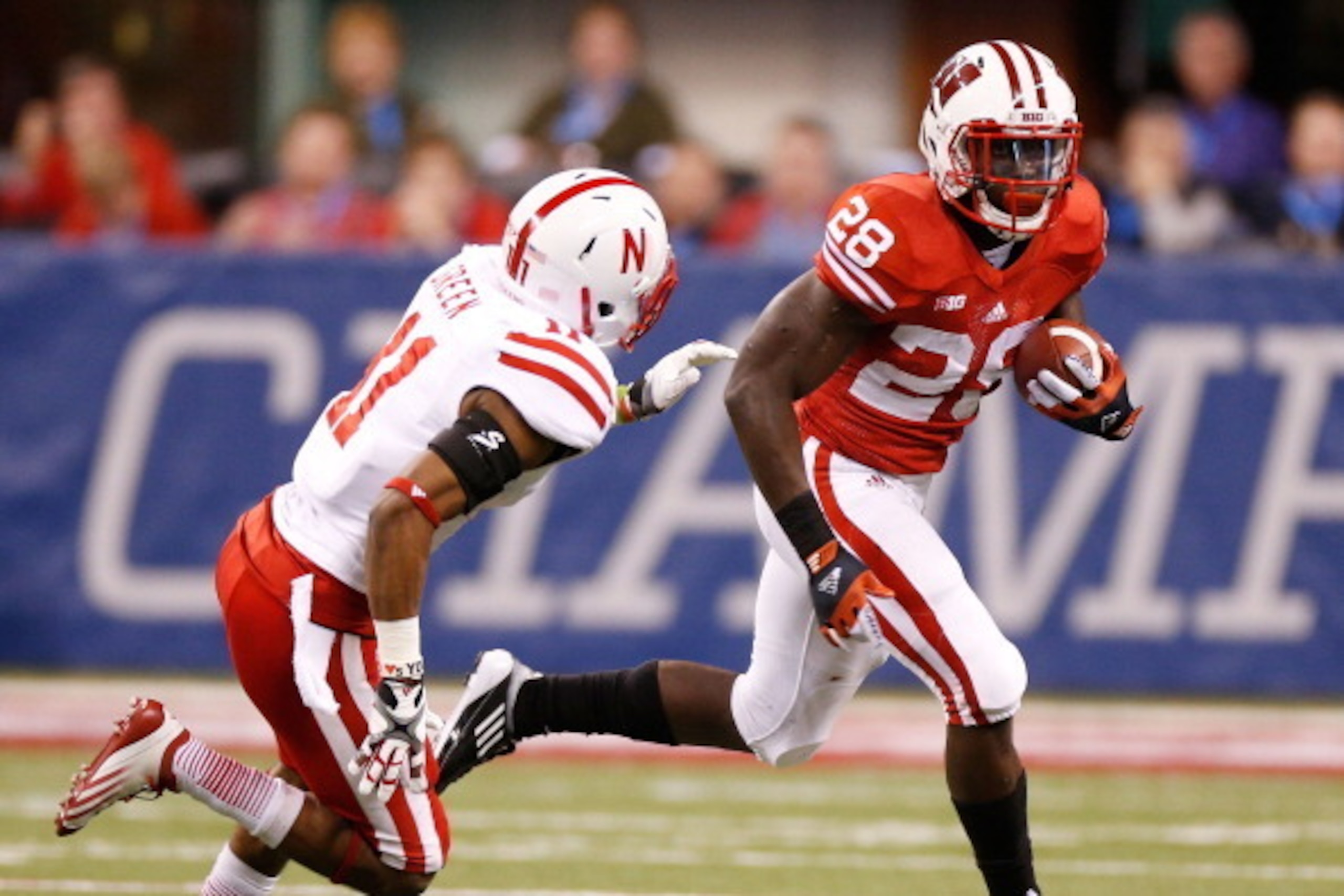 INDIANAPOLIS, IN - DECEMBER 01: Montee Ball #28 of the Wisconsin Badgers tries to get around the tackle of Andrew Green #11 of the Nebraska Cornhuskers during a second quarter run during the Big 10 Conference Championship Game at Lucas Oil Stadium on Dece