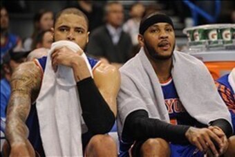 Feb 9, 2014; Oklahoma City, OK, USA; New York Knicks small forward Carmelo Anthony (7) and center Tyson Chandler (6) watch from the bench against the Oklahoma City Thunder at Chesapeake Energy Arena. Mandatory Credit: Mark D. Smith-USA TODAY Sports