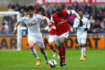 SWANSEA, WALES - MARCH 16:   Abou Diaby of Arsenal battles with Ki Sung-Yueng of Swansea City during the Barclays Premier League match between Swansea City and Arsenal at Liberty Stadium on March 16, 2013 in Swansea, Wales.  (Photo by Jan Kruger/Getty Ima