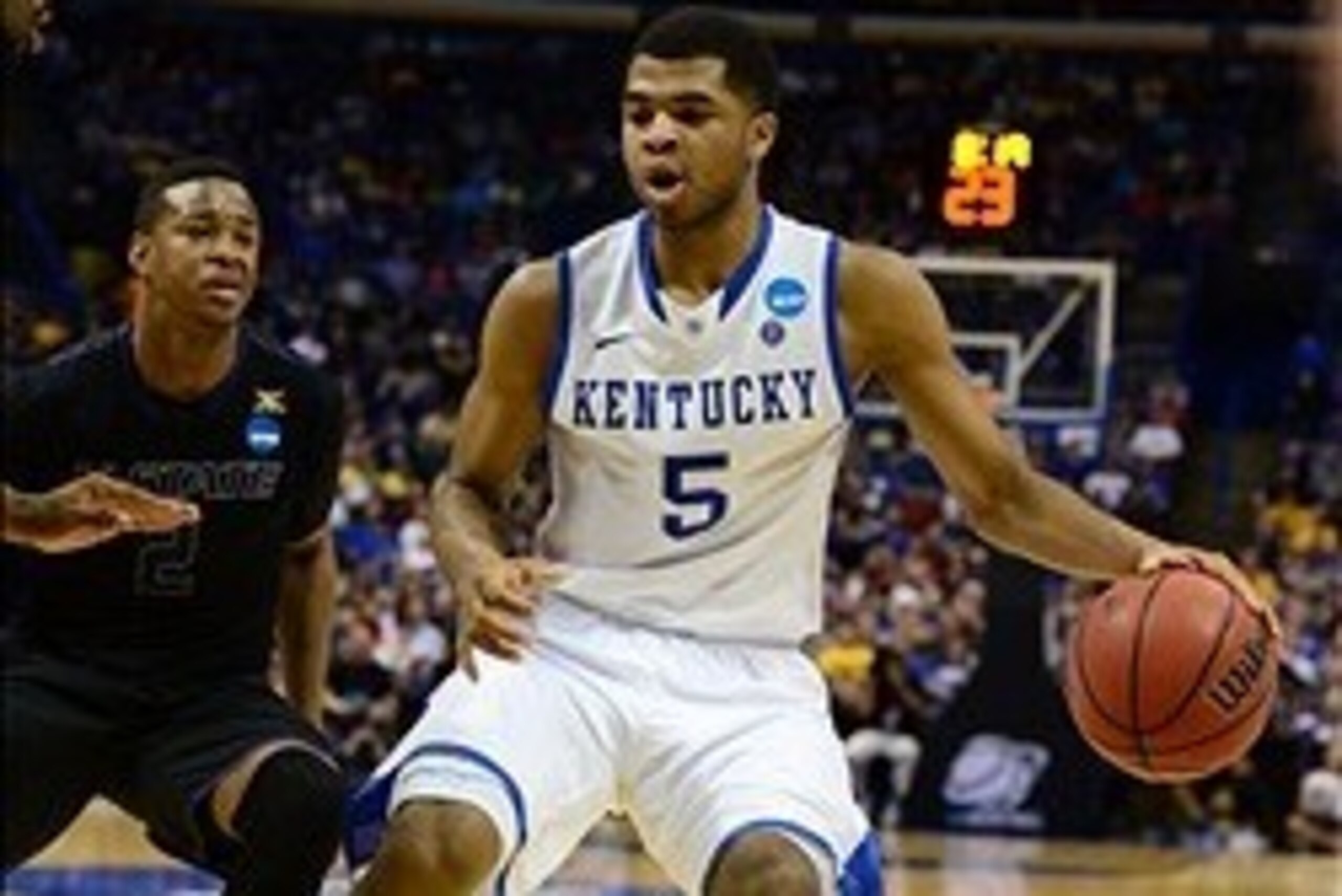 Mar 21, 2014; St. Louis, MO, USA; Kentucky Wildcats guard Andrew Harrison (5) dribbles past Kansas State Wildcats guard Marcus Foster (2) in the second half during the 2nd round of the 2014 NCAA Men's Basketball Championship at Scottrade Center. Mandatory