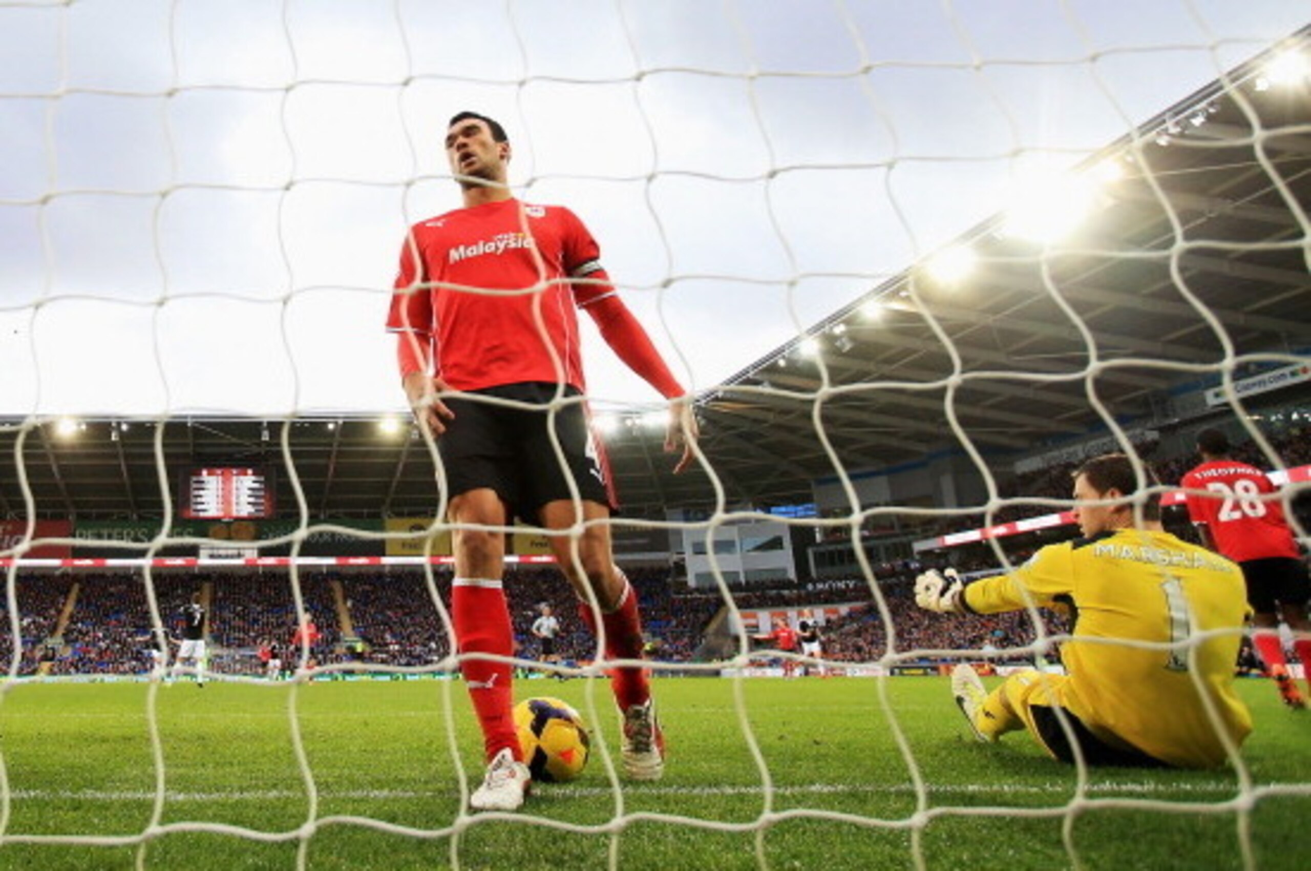 CARDIFF, WALES - DECEMBER 26: Goalkeeper David Marshall and Steven Caulker of Cardiff City look dejected after the first goal scored by Jay Rodriguez of Southampton during the Barclays Premier League match between Cardiff City and Southampton at Cardiff C