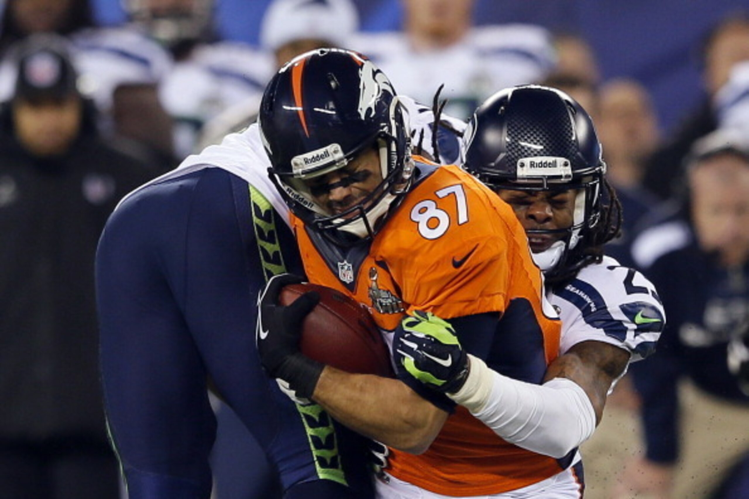 EAST RUTHERFORD, NJ - FEBRUARY 02:  cornerback Richard Sherman #25 of the Seattle Seahawks tackles wide receiver Eric Decker #87 of the Denver Broncos during Super Bowl XLVIII at MetLife Stadium on February 2, 2014 in East Rutherford, New Jersey.  (Photo 