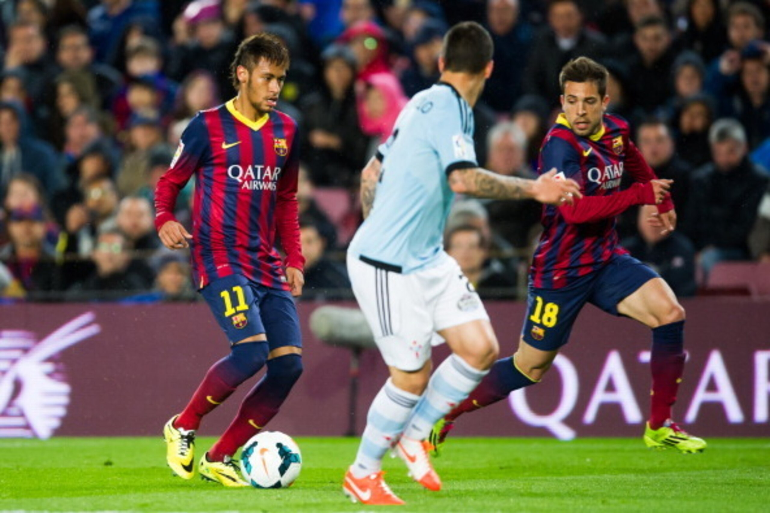 BARCELONA, SPAIN - MARCH 26: Neymar Santos Jr (L) and Jordi Alba (R) of FC Barcelona in action beside Hugo Mallo of RC Celta de Vigo during the La Liga match between FC Barcelona and RC Celta de Vigo at Camp Nou on March 26, 2014 in Barcelona, Spain. (Pho