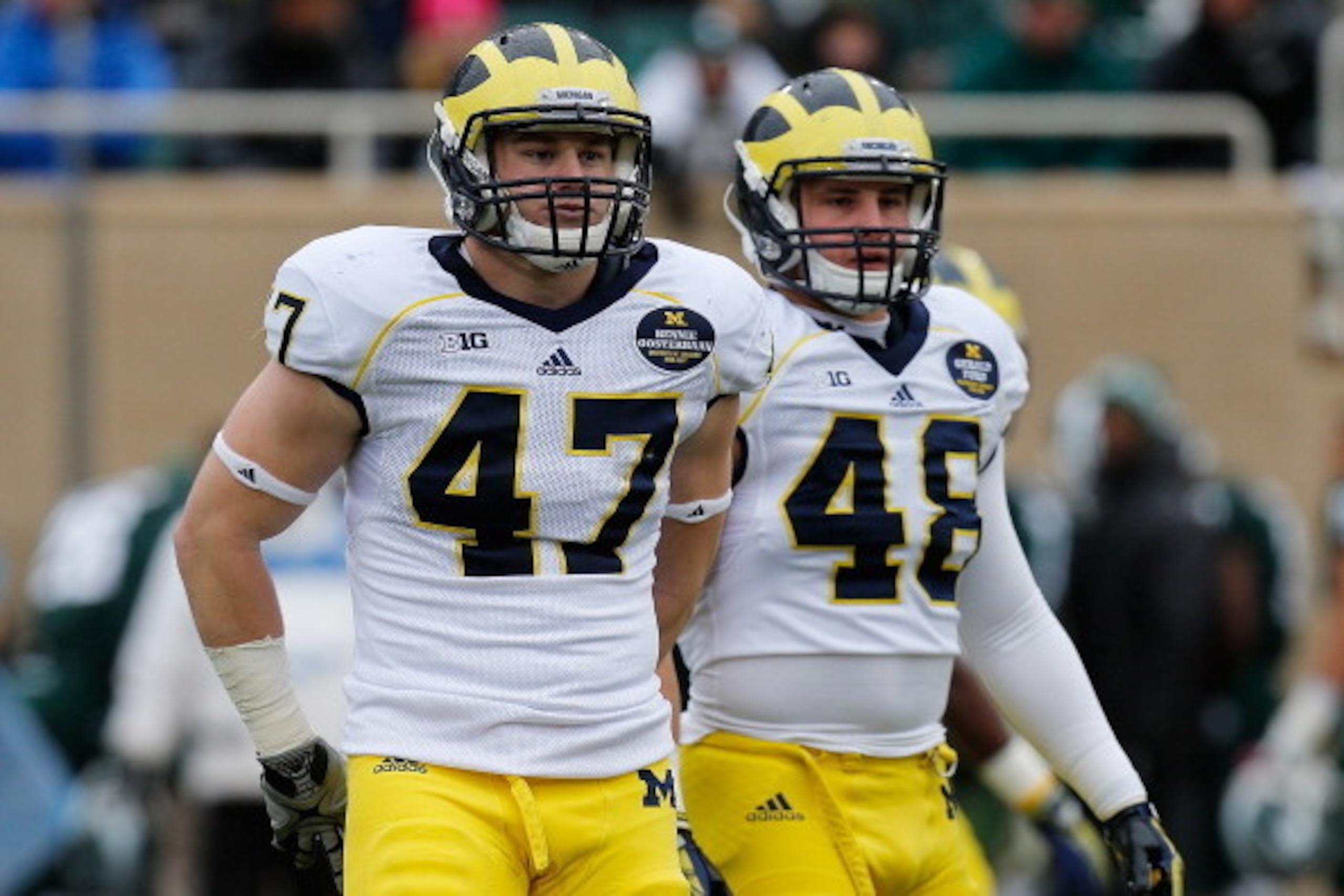 EAST LANSING, MI - NOVEMBER 02: Jake Ryan #47 and Desmond Morgan #48 of the Michigan Wolverines take a break in between plays against the Michigan State Spartans at Spartan Stadium on November 2, 2013 in East Lansing, Michigan. (Photo by Gregory Shamus/Ge