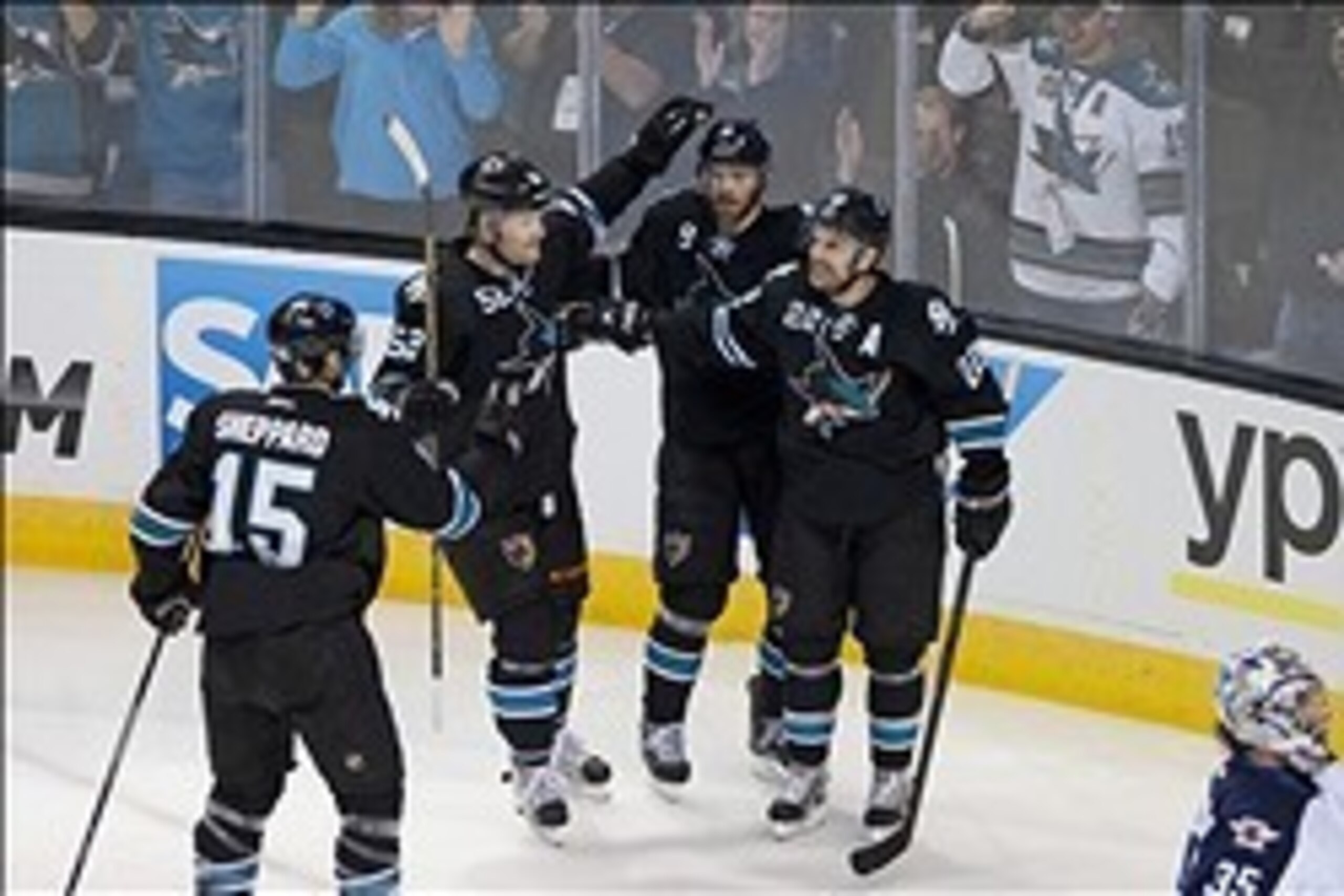 Mar 27, 2014; San Jose, CA, USA; San Jose Sharks left wing James Sheppard (15) and defenseman Matt Irwin (52) and right wing Martin Havlat (9) celebrate with defenseman Dan Boyle (22) after he scored a goal against the Winnipeg Jets during the first perio