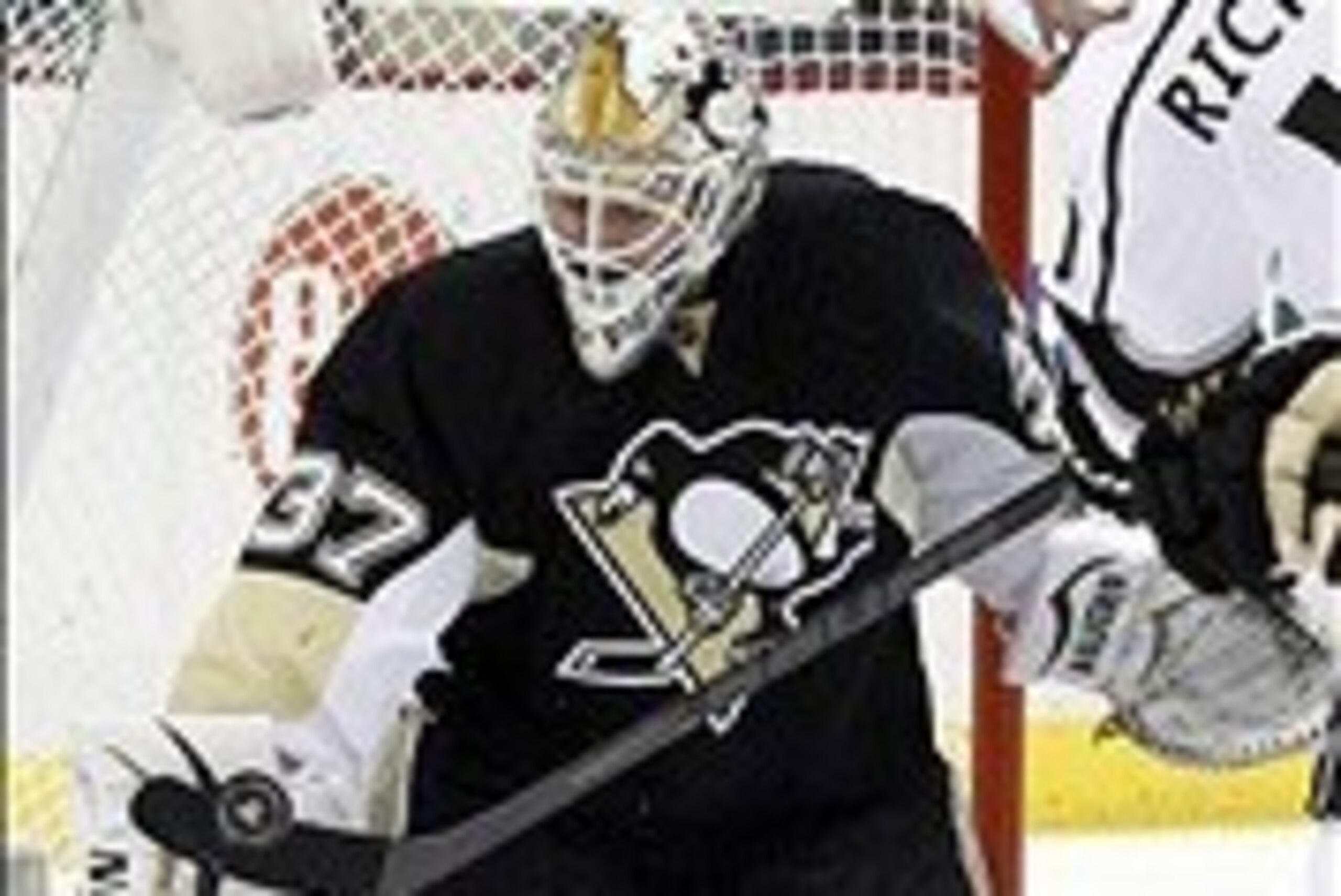 Mar 27, 2014; Pittsburgh, PA, USA; Pittsburgh Penguins goalie Jeff Zatkoff (37) makes a save against Los Angeles Kings center Mike Richards (10) during the first period at the CONSOL Energy Center. Mandatory Credit: Charles LeClaire-USA TODAY Sports